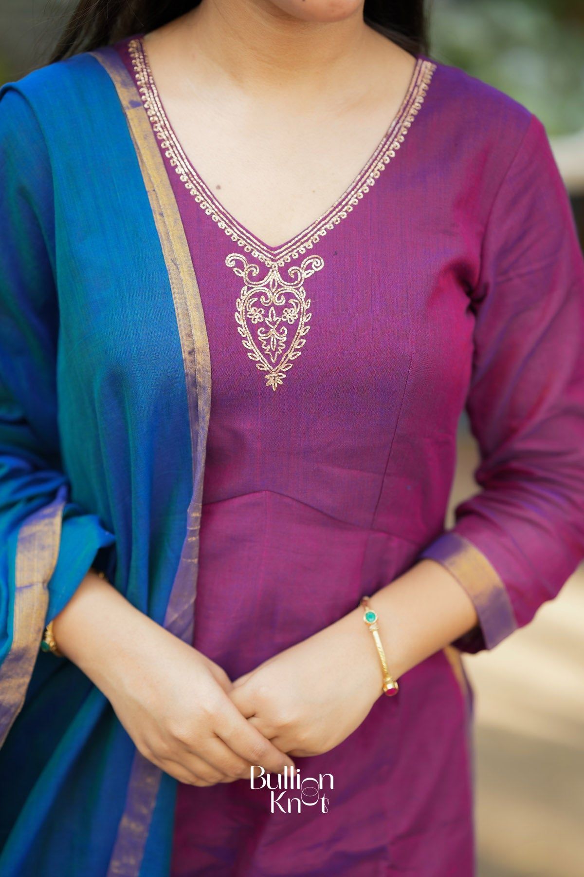 Close-up of purple kurta neckline with embroidery, traditional clothing detail