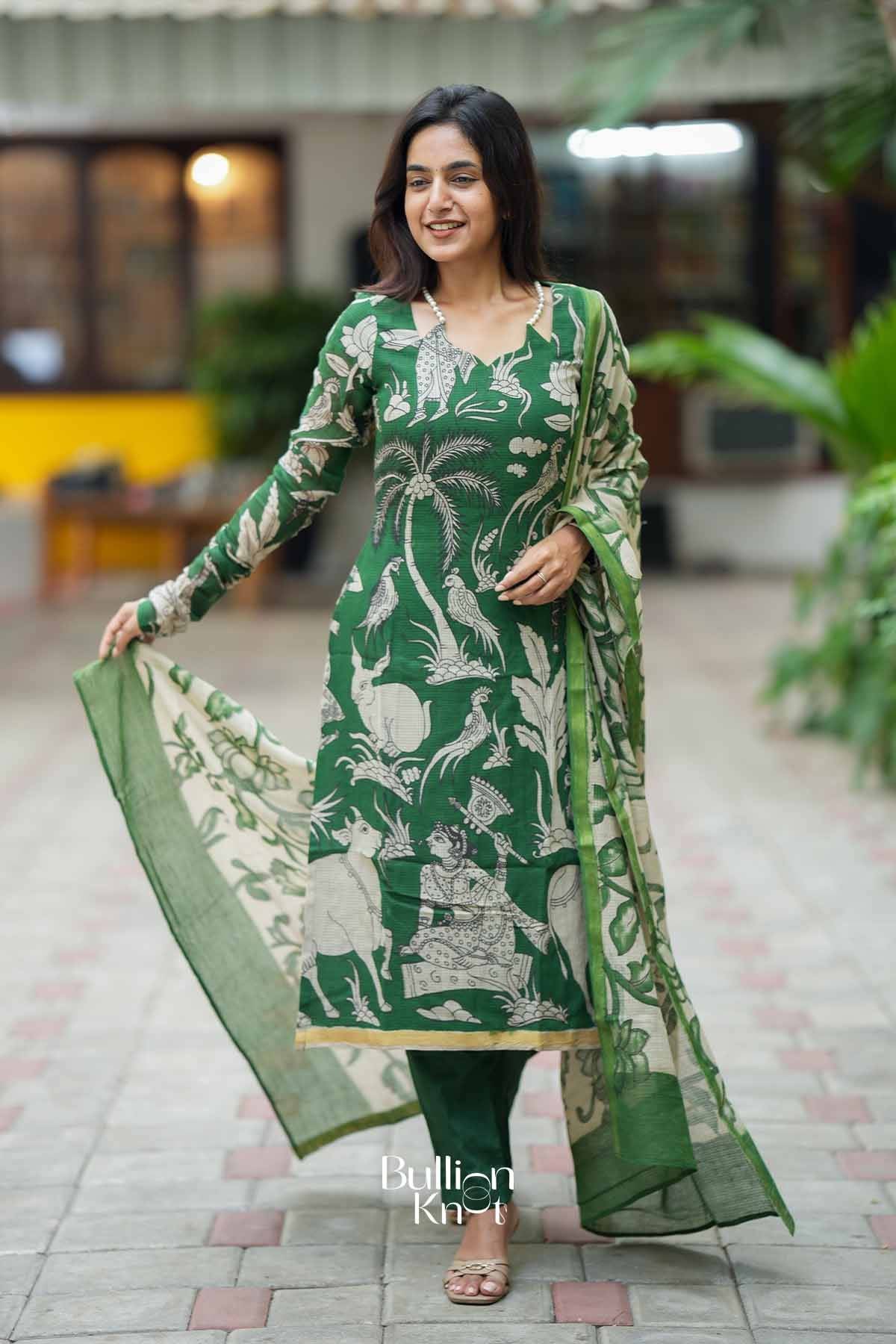 Front view of a woman wearing a stylish green kurta with vibrant white motifs, accessorized with pearl necklace, suitable for festive occasions.