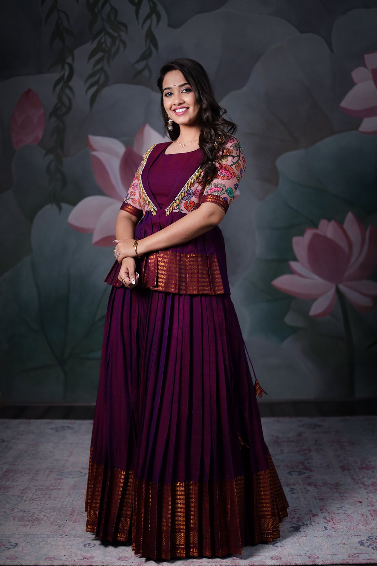 a woman in purple half saree