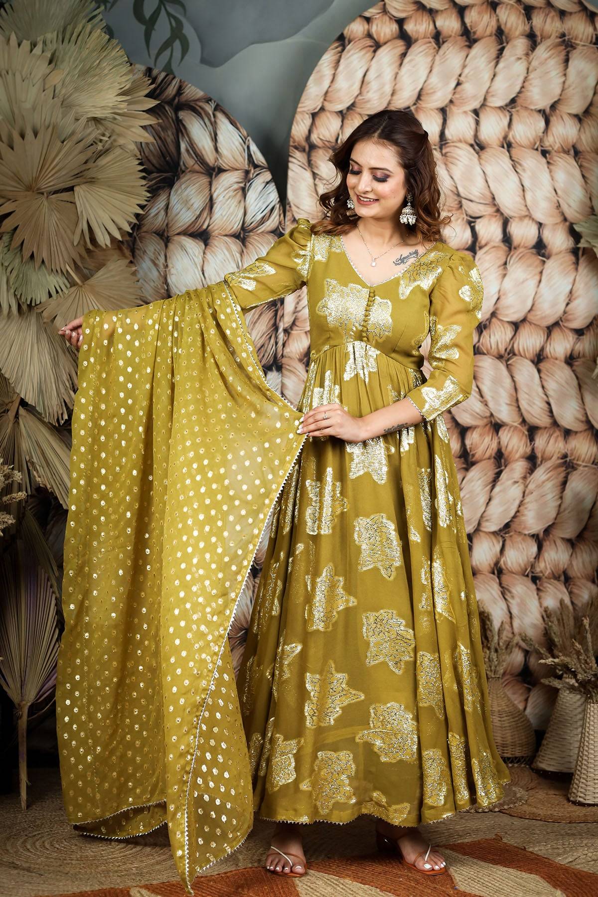 a woman in golden anarkali dress