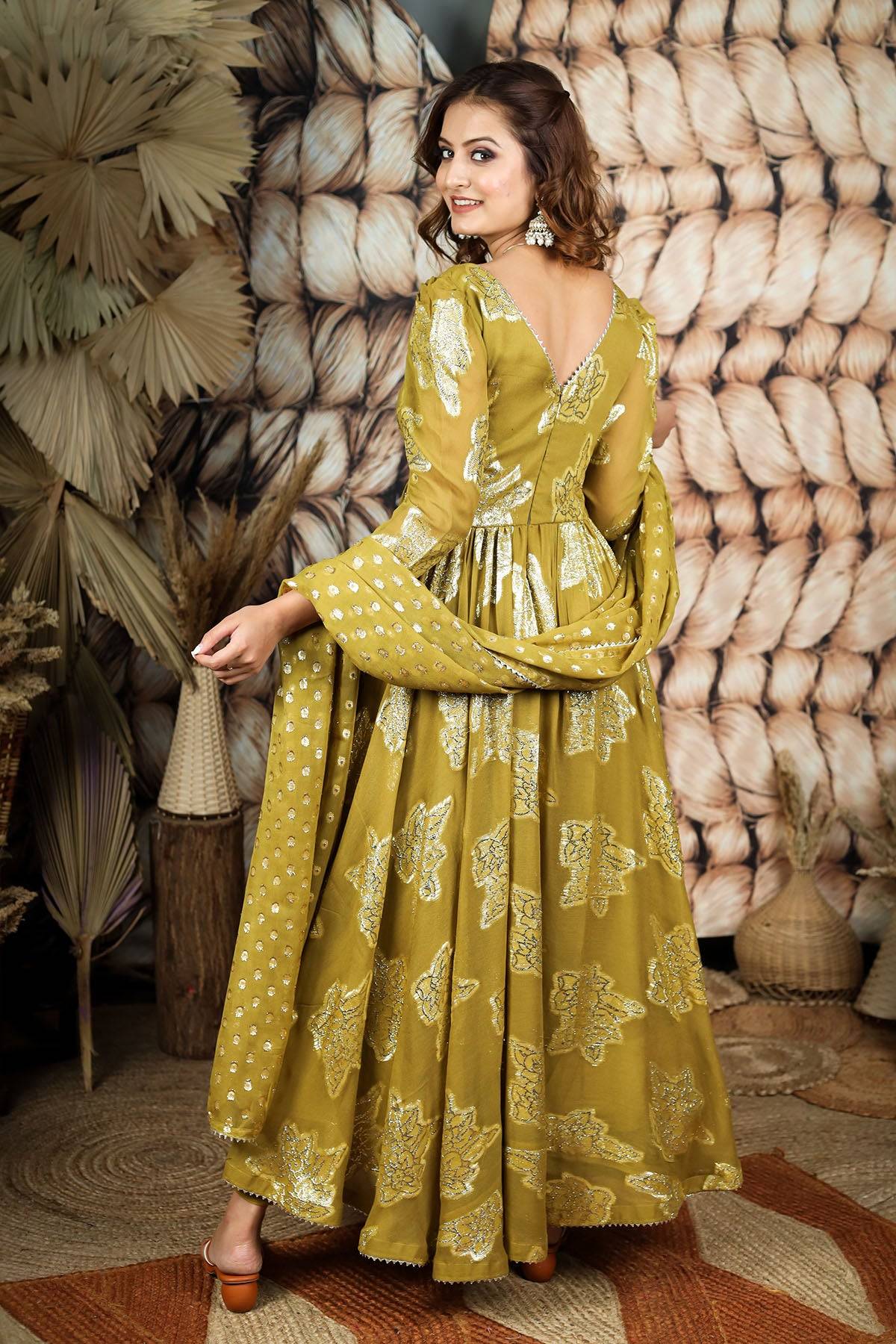 a woman in green pattu dress
