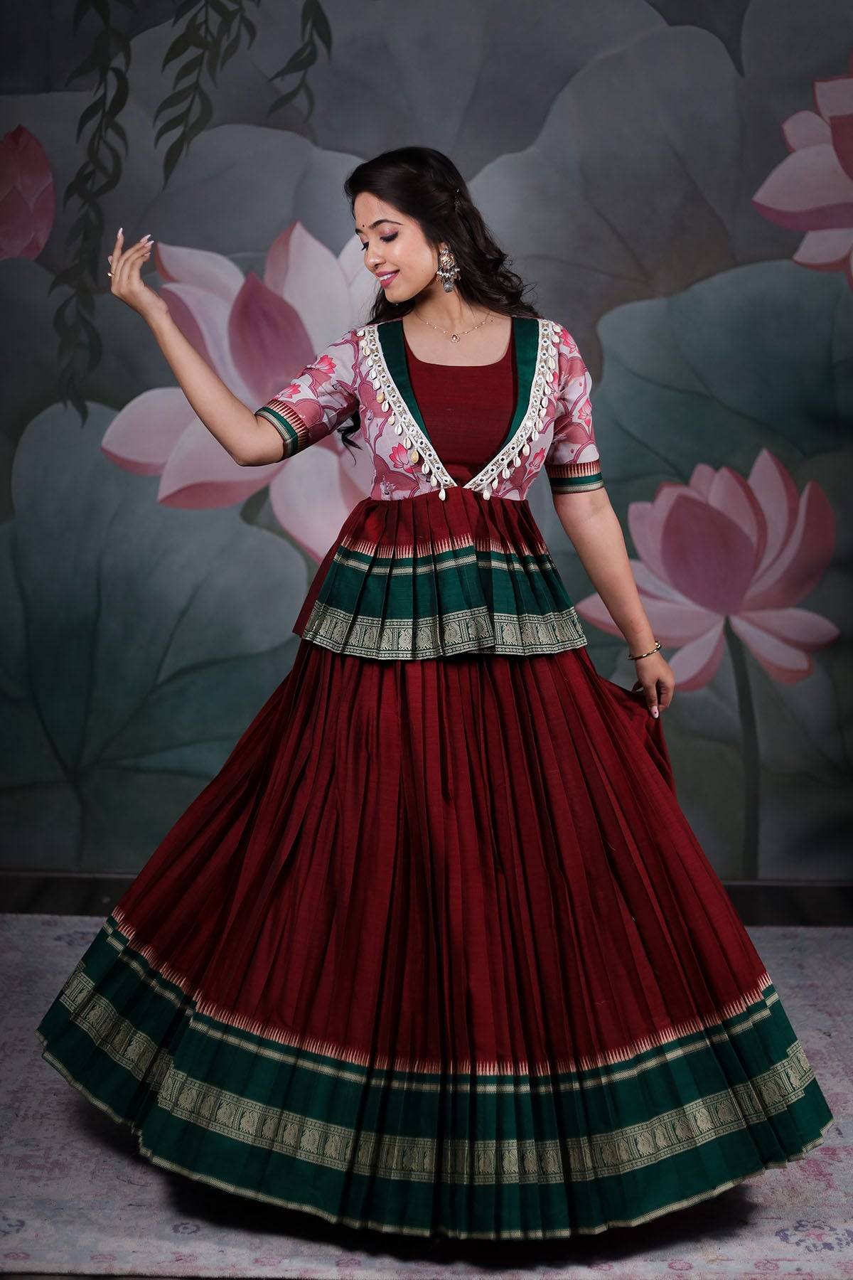 a woman in maroon peplum lehenga set