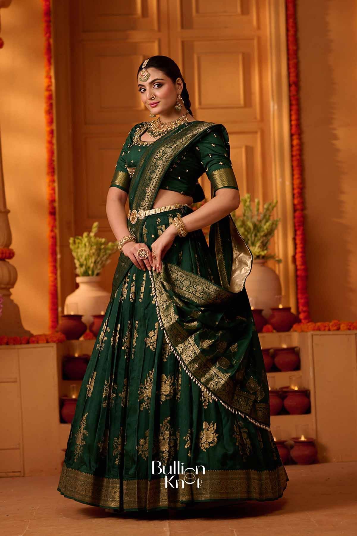 Elegant green and gold traditional lehenga set with intricate embroidery, matching blouse, and ornate jewelry for festive wear.
