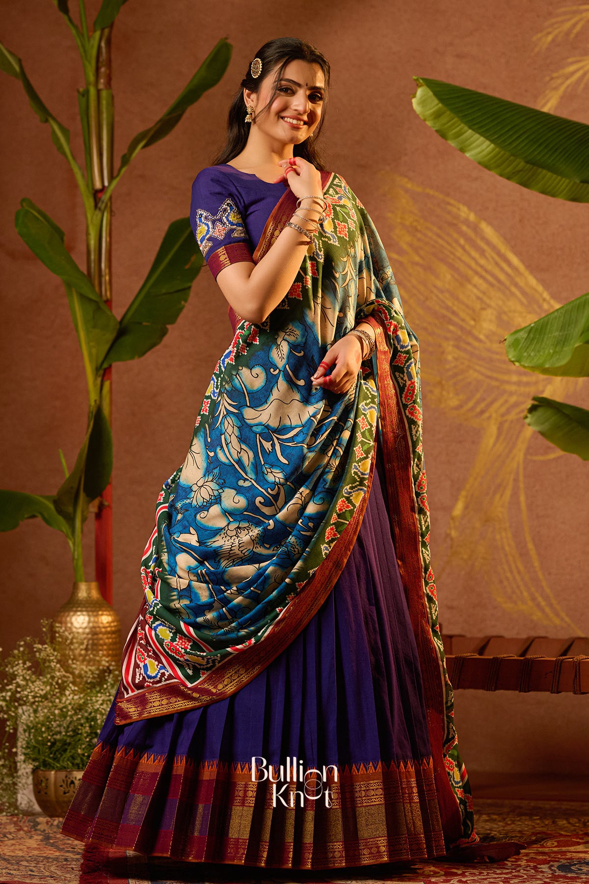 Cultural half saree with pleated flare and meaningful blouse design