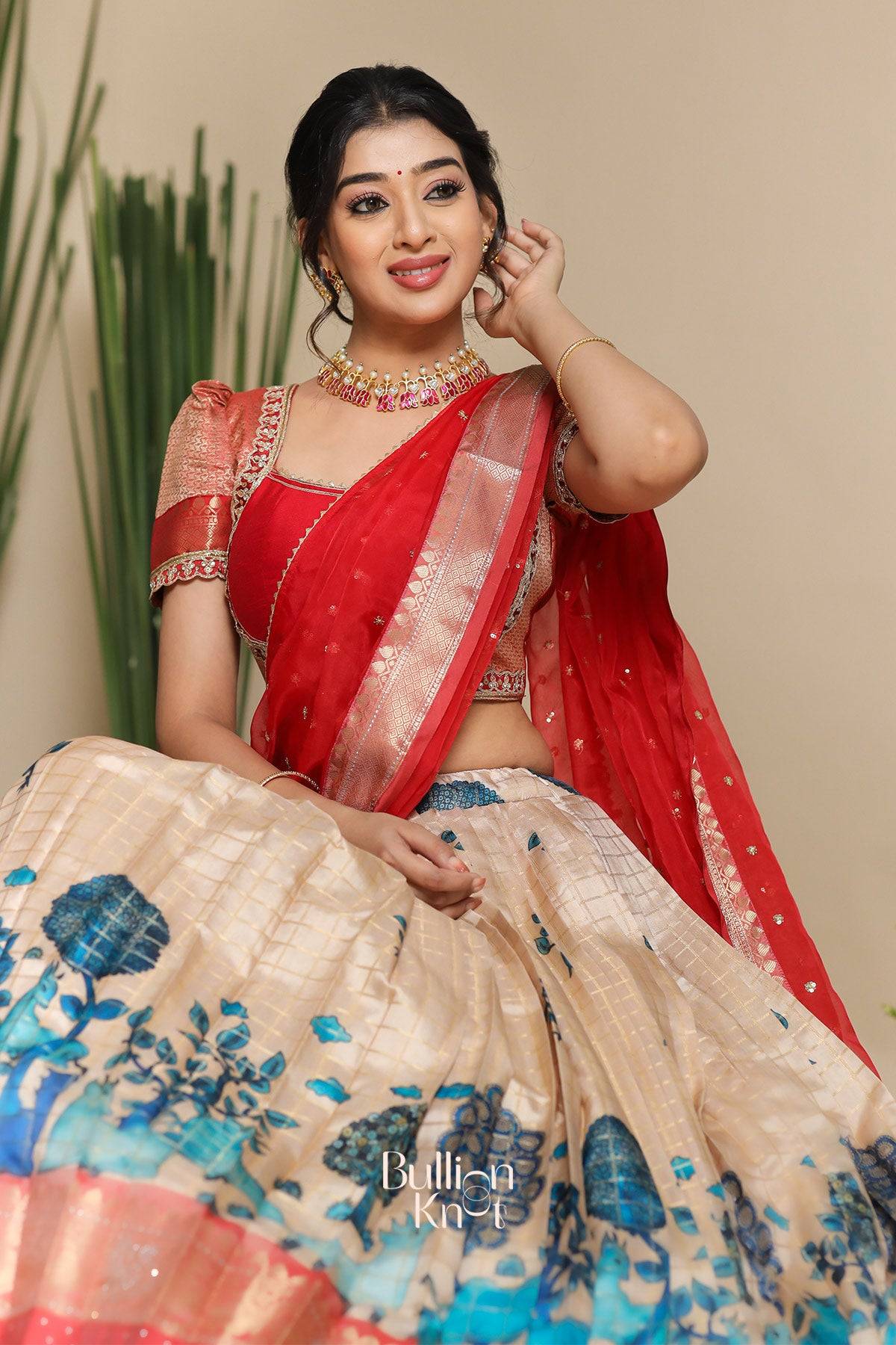 a beautiful women in red saloni banarasi lehenga set