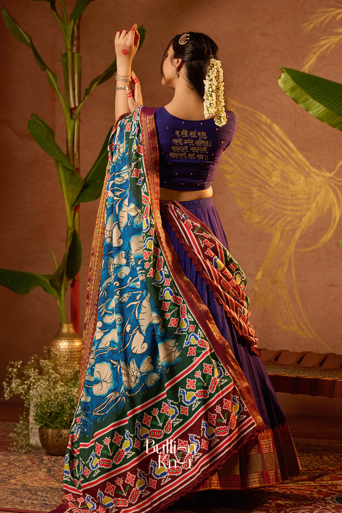 Elegant lehenga set with devotional blouse back and woven details
