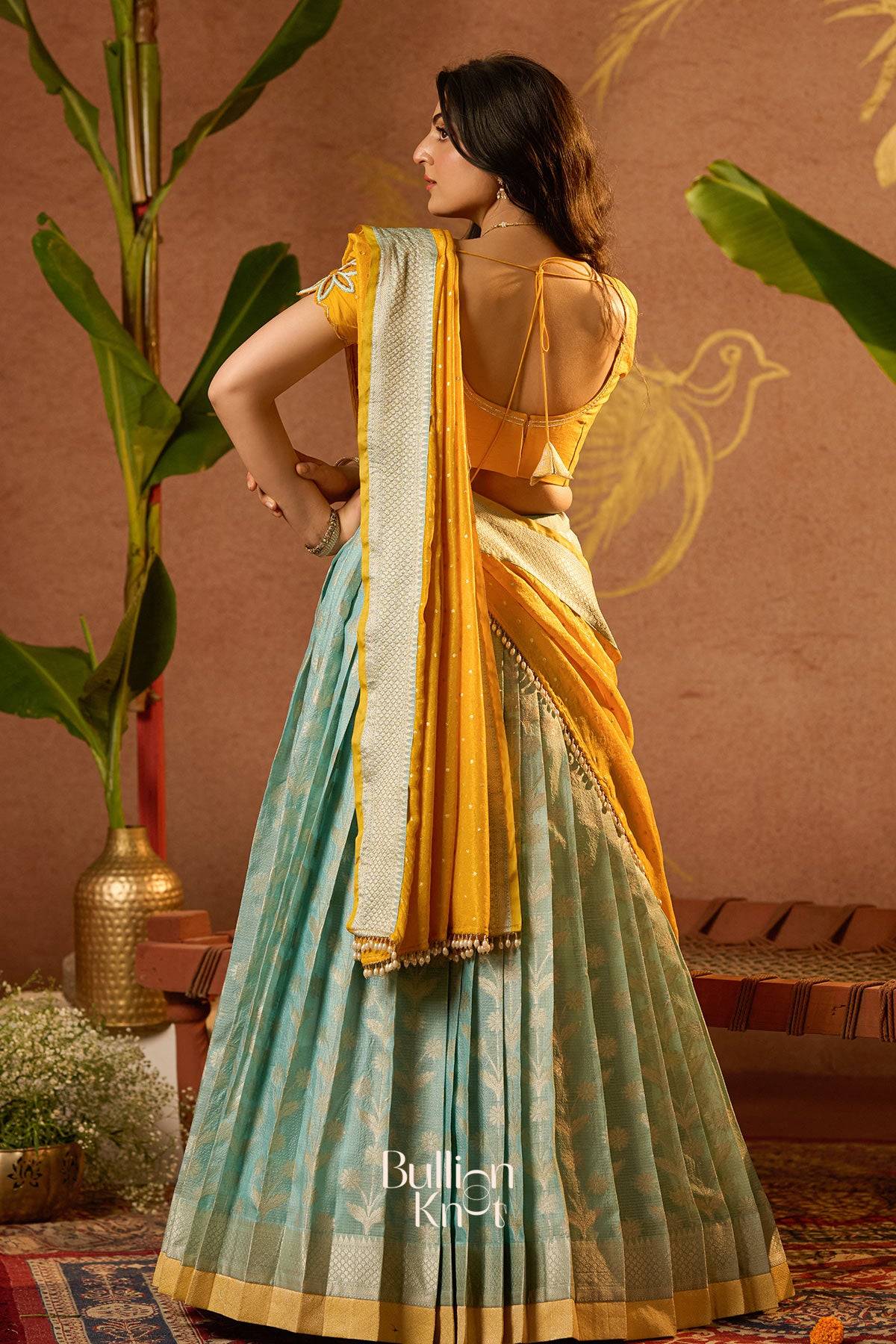 Woman wearing a yellow and green Lehenga