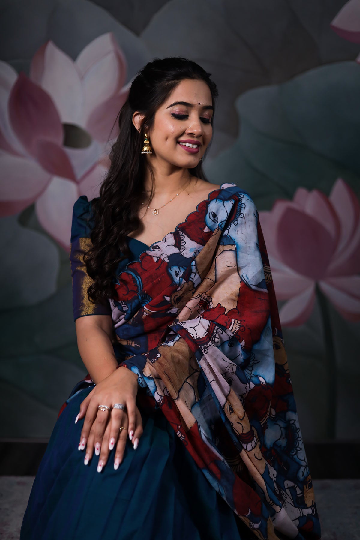 a model with dark blue half saree with cotton embroidery cutwork dupatta sitting on bench from Bullionknot