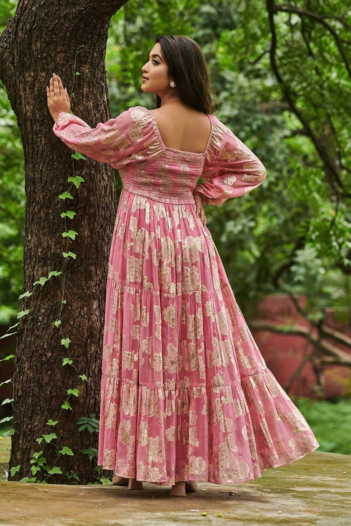 Back view of Sitara Floral Zari Maxi Dress in Pink, nature setting