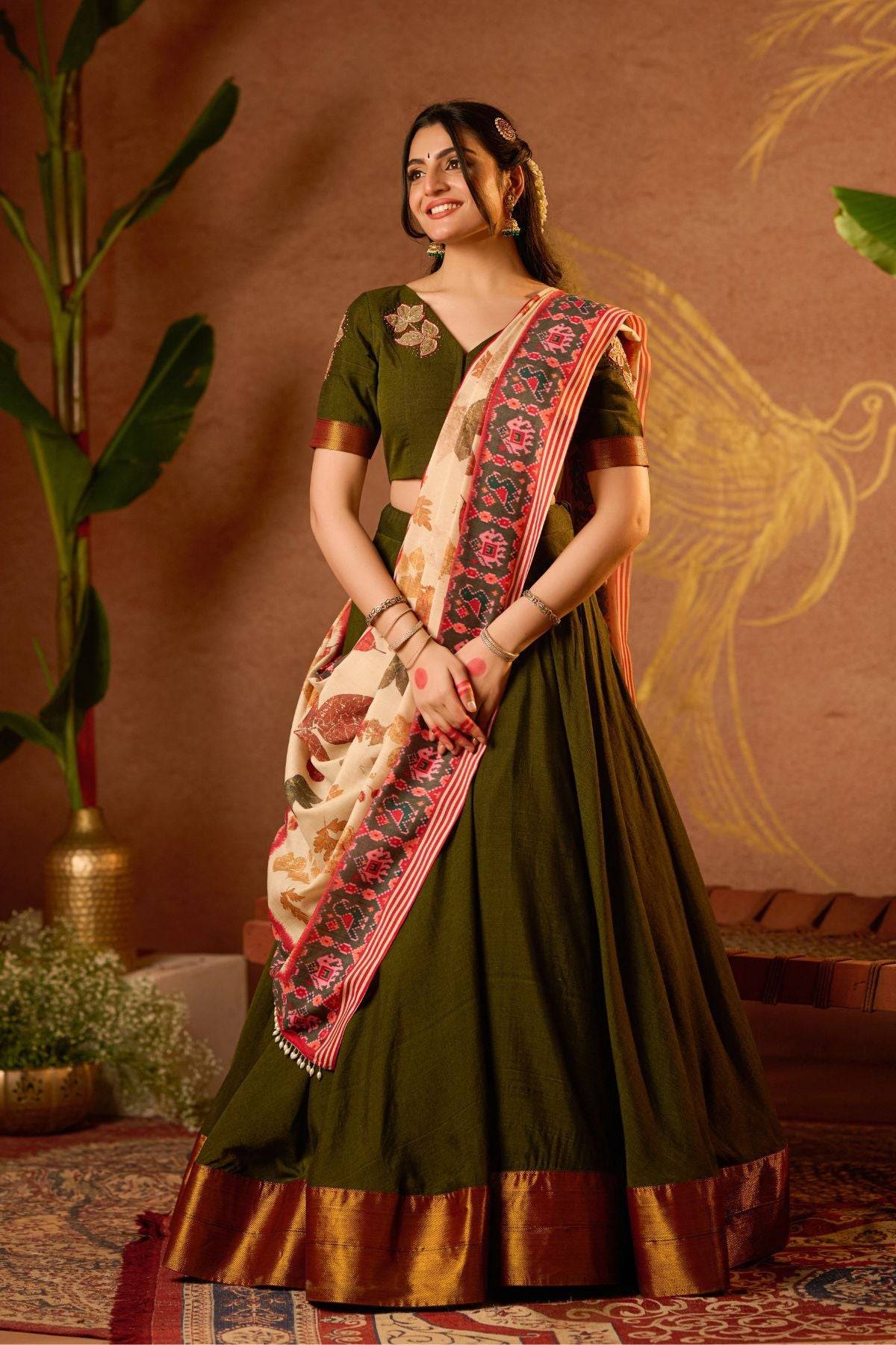 Exclusive Lehenga - Tithi Lehenga Set in Mehendi at bullionknot featuring a deep green flared skirt with copper border and floral dupatta. Ideal for festive and traditional occasions.