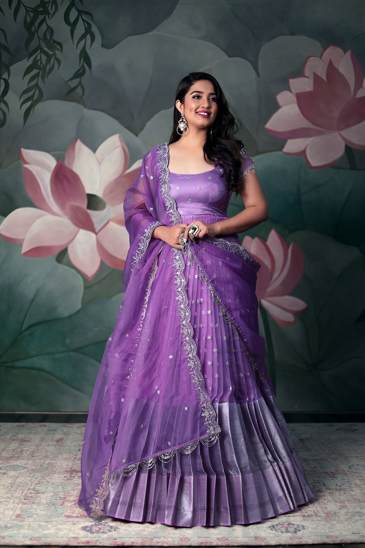 a women in violet Anarkali Suit