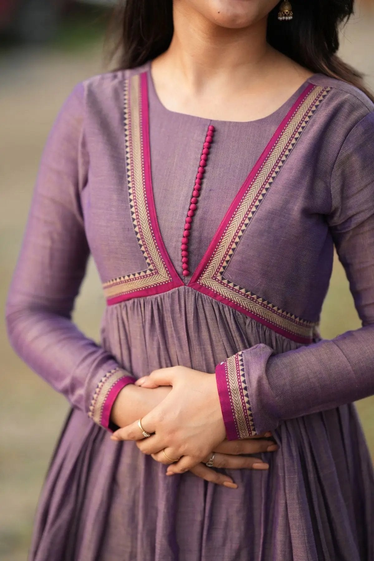 Detailed view of Lipika Kurta Set's neckline and sleeve embroidery in pink and gold, showcasing fine craftsmanship in traditional attire.
