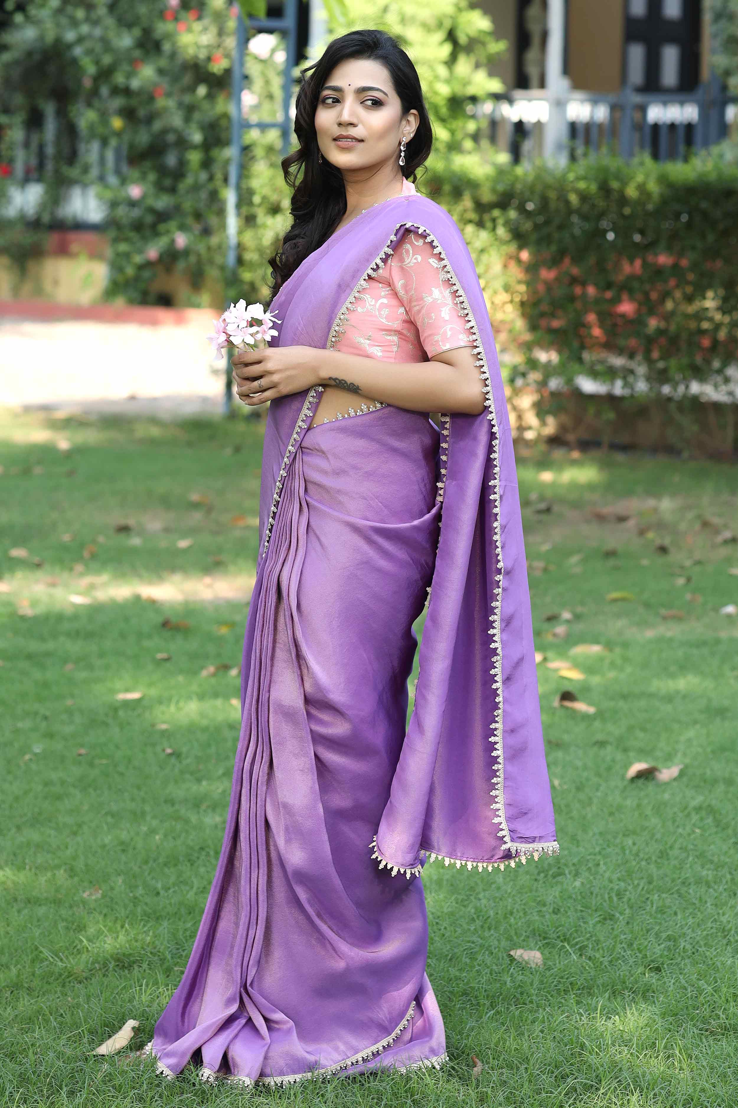 a woman in violet Zari Saree