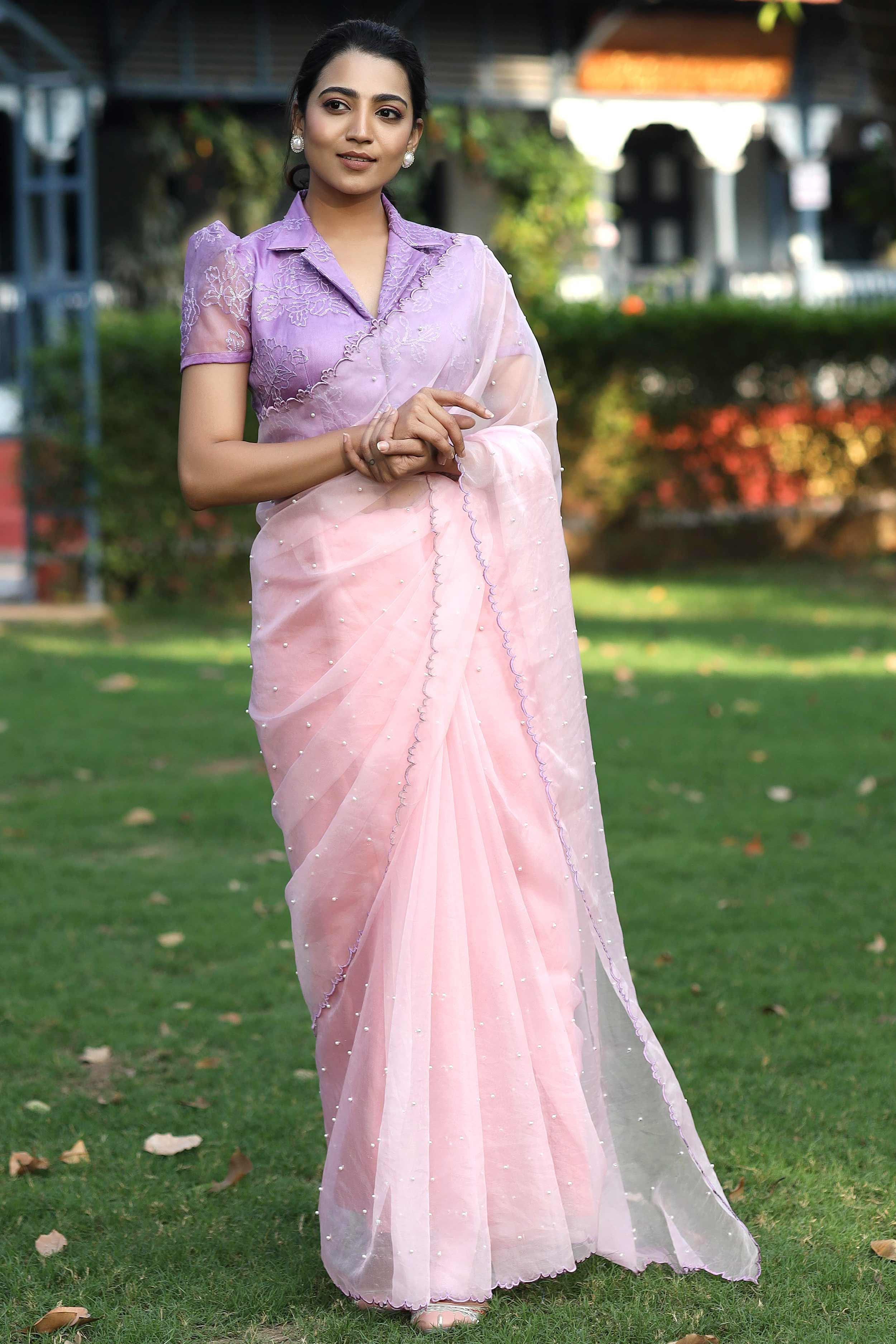 a woman in pink organza saree