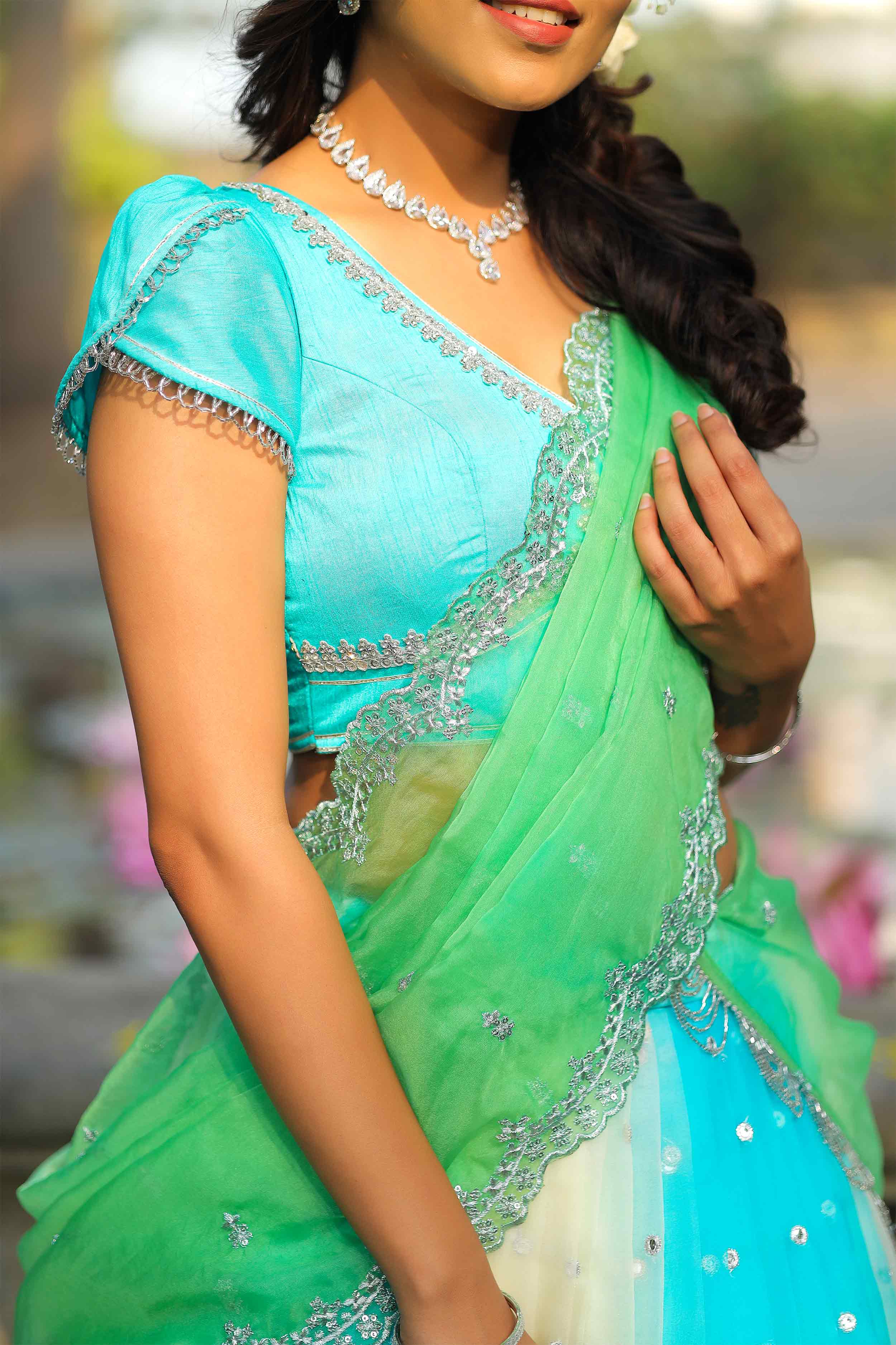 a woman in a green and blue sari