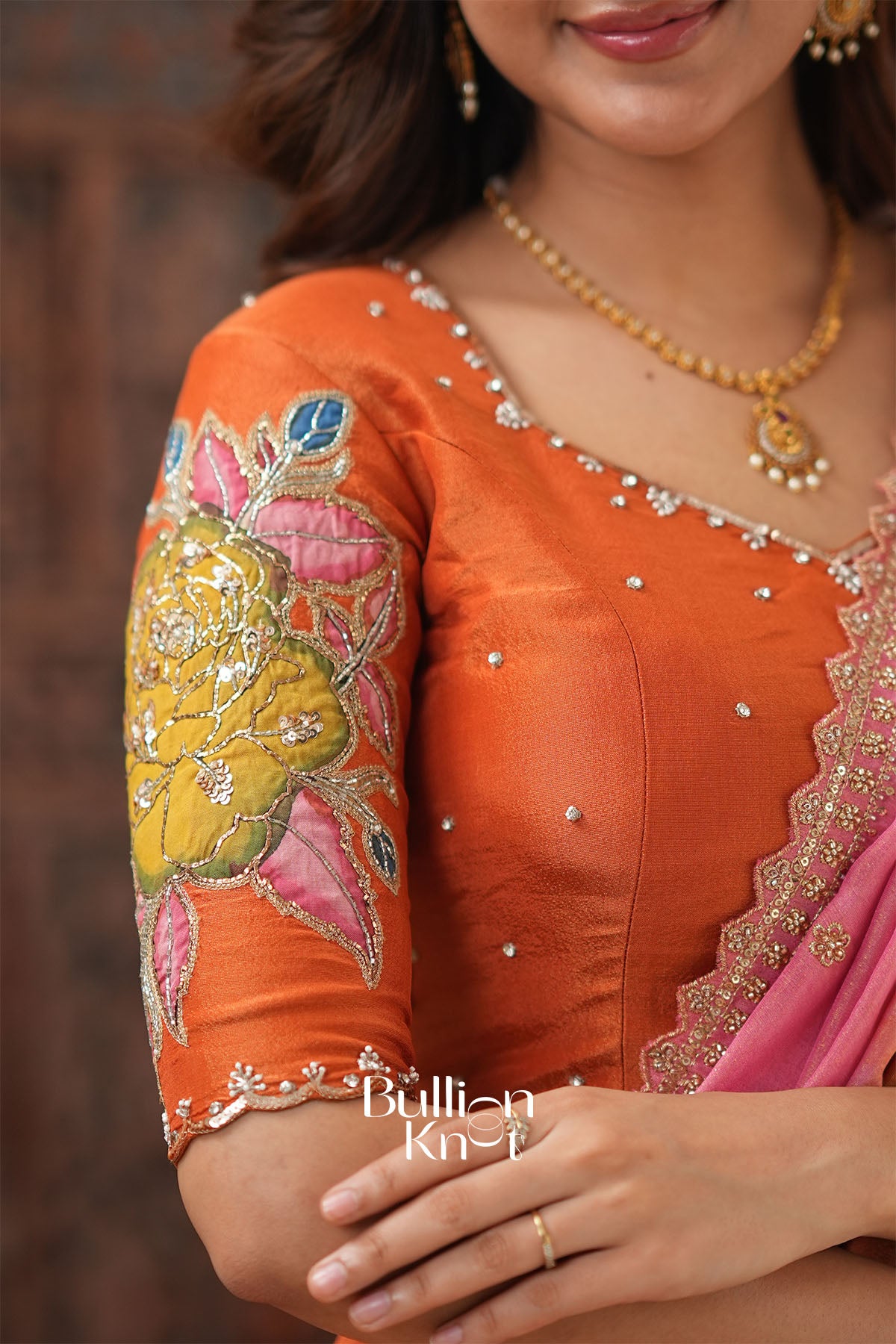 Close-up of Embroidered Sleeve and Back of Rusty Orange Lehenga