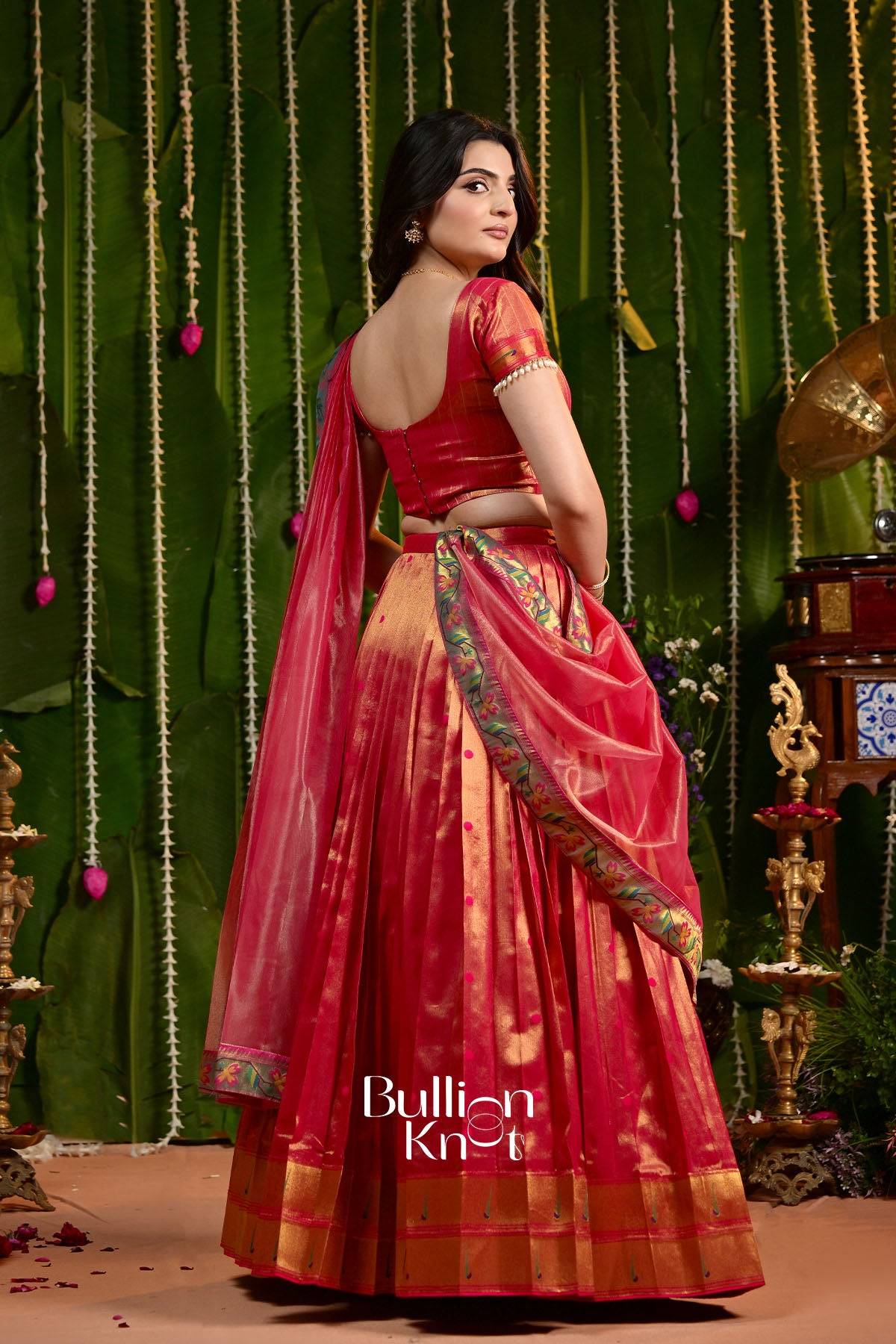 Back view of woman in vibrant red Rajwadi Paithani Silk Lehenga with detailed border