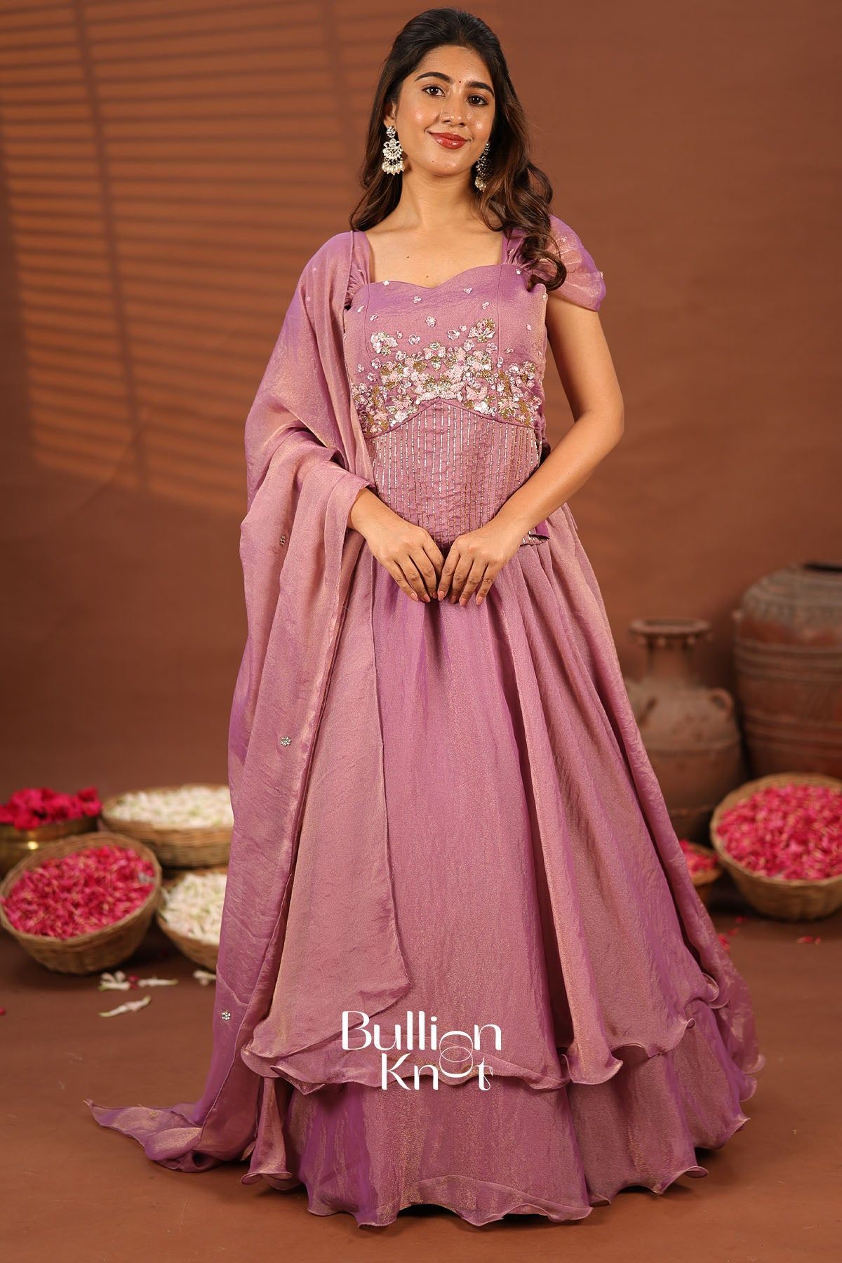 Close-up of pink embroidered dress with embellishments and puff sleeves