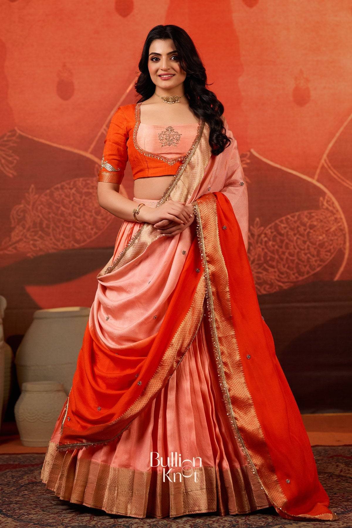 Exclusive Lehenga - Kaavya Dola Lehenga Set in Orange at bullionknot featuring a peach and orange silk blend with zari border, ideal for traditional events.