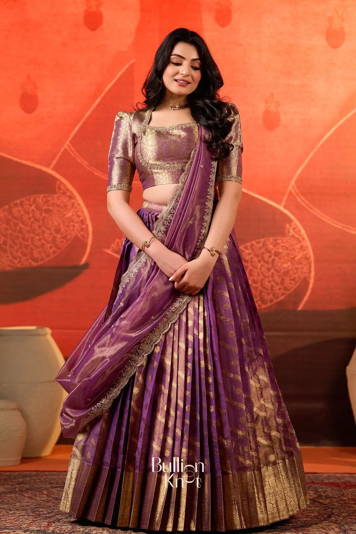 Urja lehenga set in Purple at bullionknot showcasing rich Banarasi pleats and gold zari detailing, ideal for festive and wedding attire.