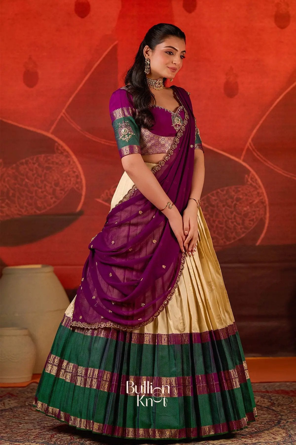 Side pose of model in Vishakha Half Saree in Vanilla at bullionknot, highlighting the luxurious purple dupatta and detailed blouse embroidery.