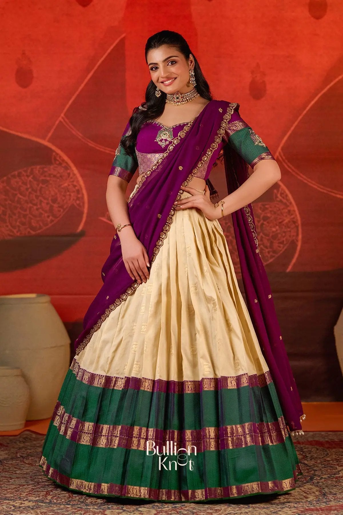 Full view of Exclusive Lehenga - Vishakha Half Saree in Vanilla at bullionknot, combining a vanilla skirt, green border, and purple dupatta for a regal look.