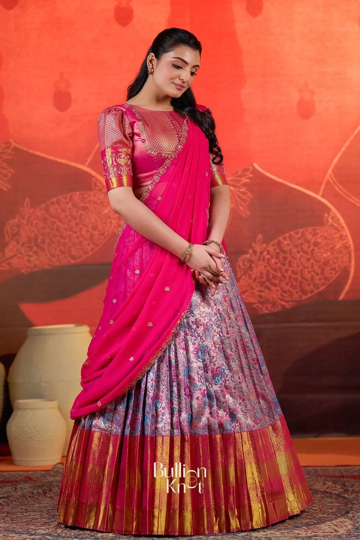 Traditional Pranjal Silk Lehenga Set in Pink at bullionknot with pleated floral Banarasi skirt and gold zari border, ideal for festive wear.