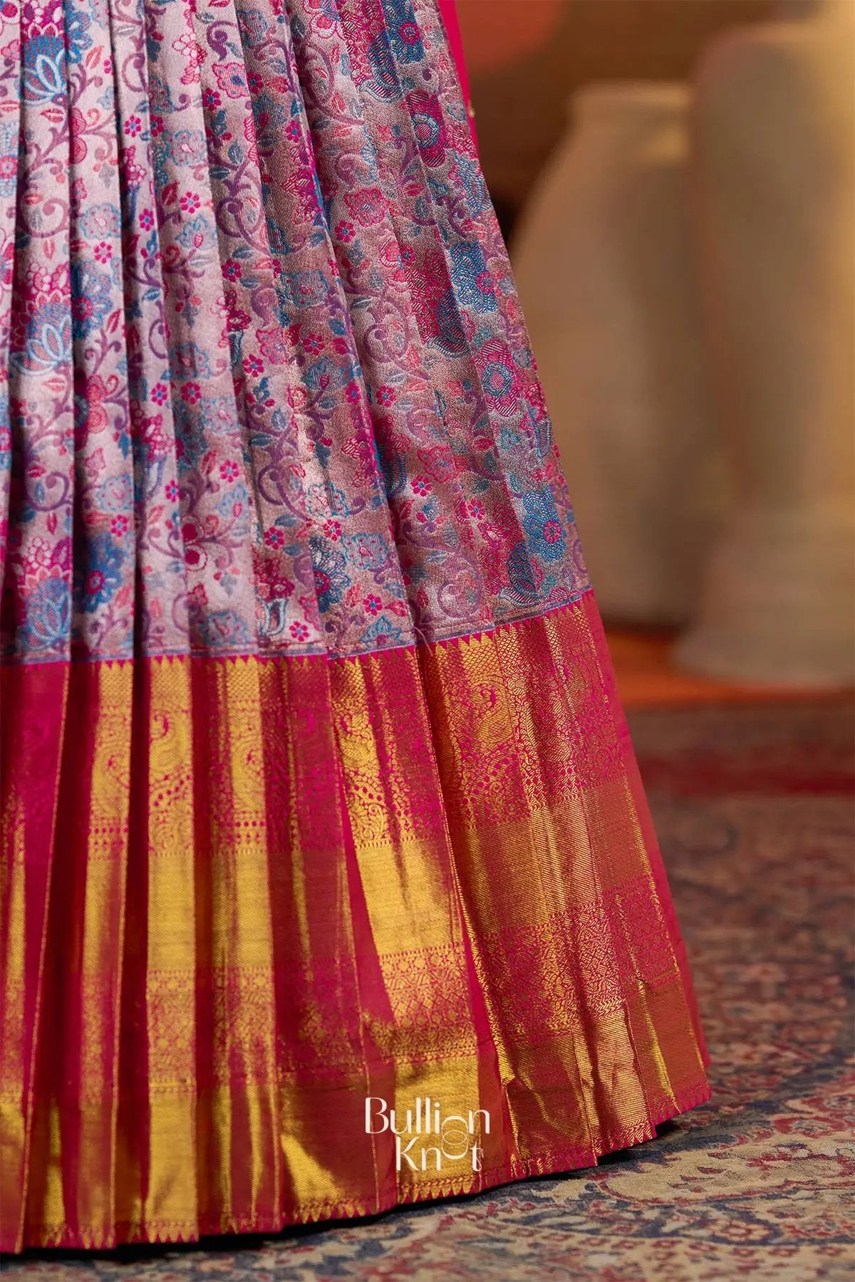 Detailed view of the Pranjal Silk Lehenga Set in Pink at bullionknot showing the golden zari border and intricate Banarasi weave.