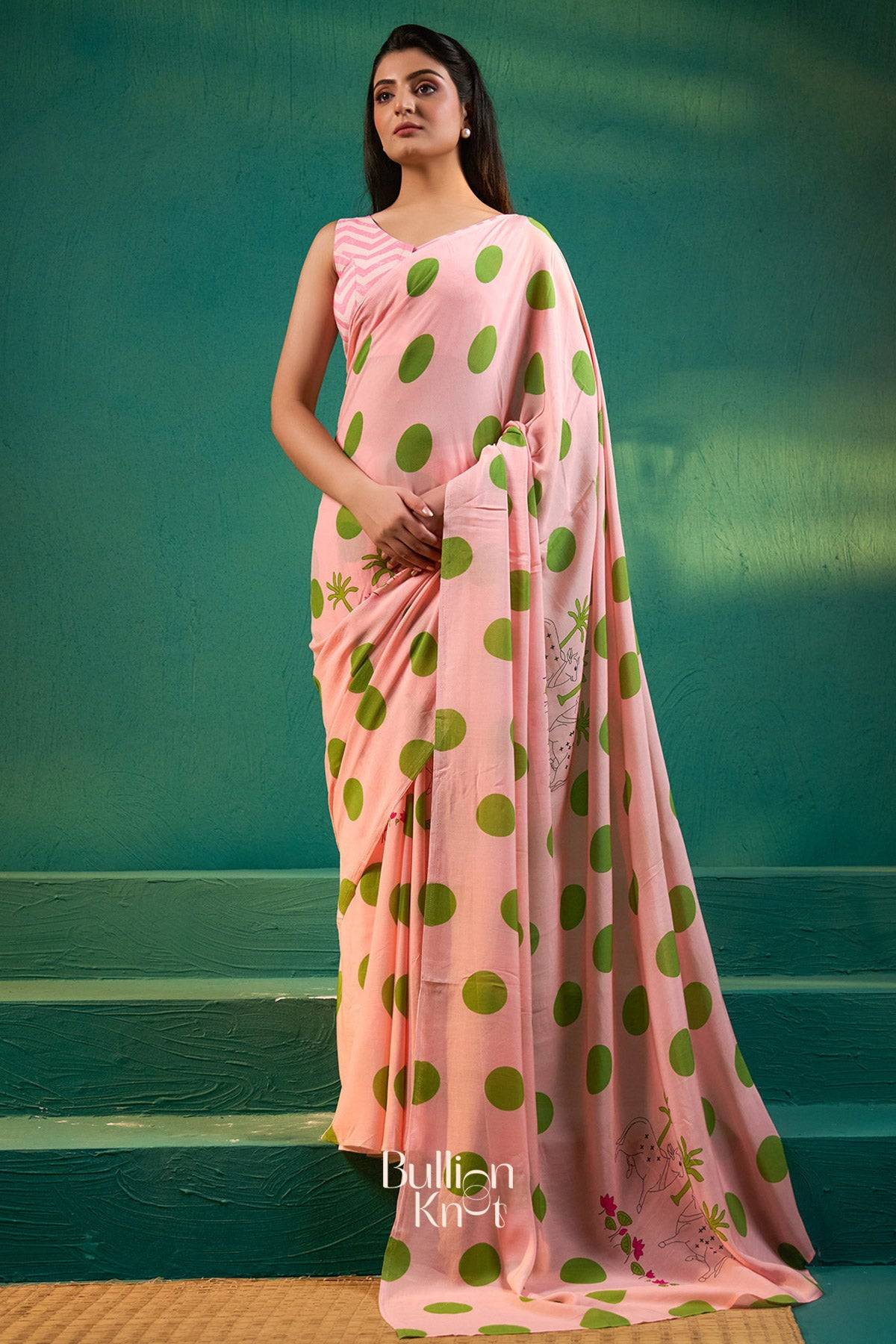 Full view of Raveena Saree in Baby Pink at bullionknot, featuring bold green polka dots and festive embroidery for ceremonial occasions.