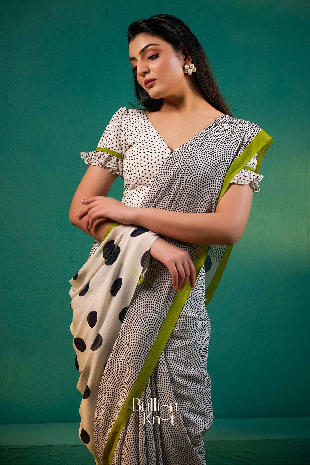 Karishma Saree in Black from Exclusive Sarees at bullionknot, styled with a polka dot pallu and contrast green edging for a chic ethnic look.