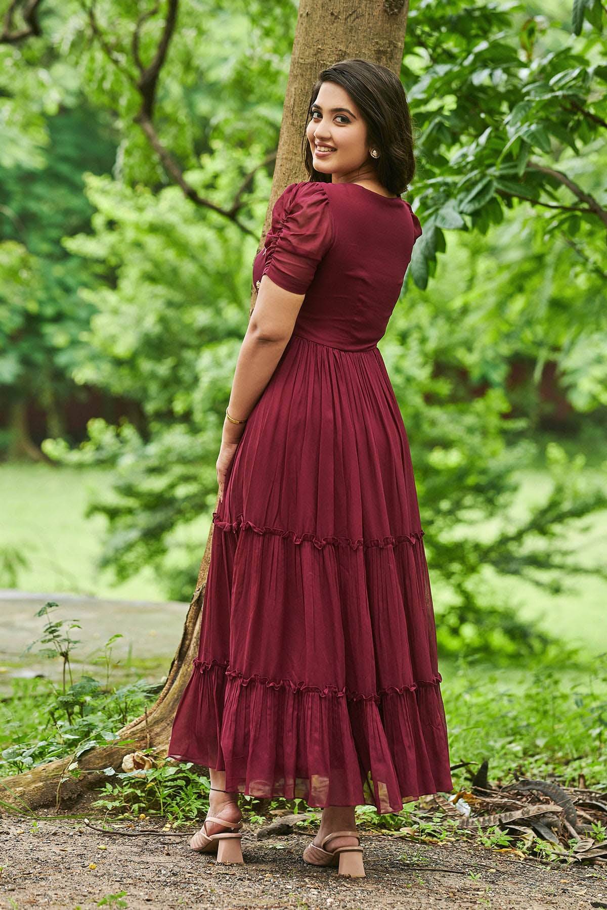 a woman in maroon Georgette Frock
