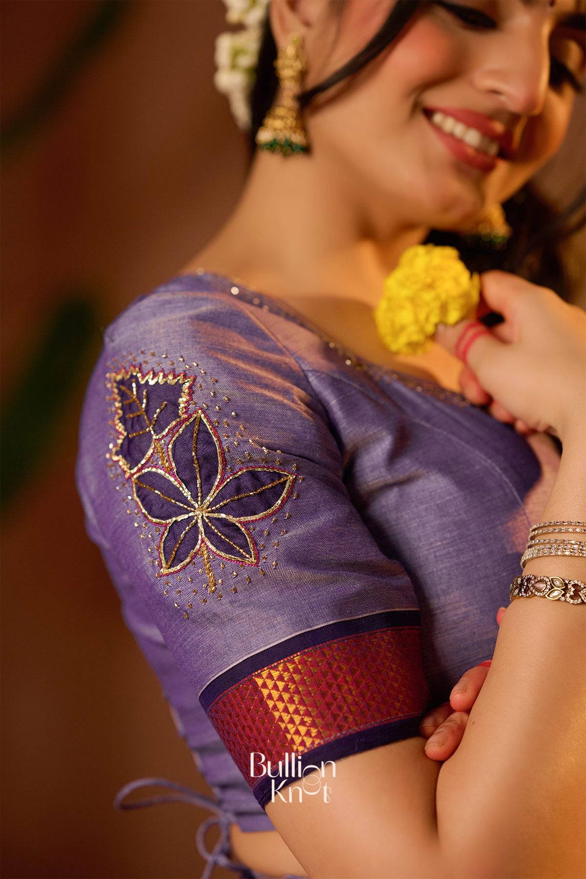 Close-up of Nupur Handloom Lehenga Set in Lavender showcasing intricate floral embroidery on blouse sleeve, perfect for festive and ceremonial wear.