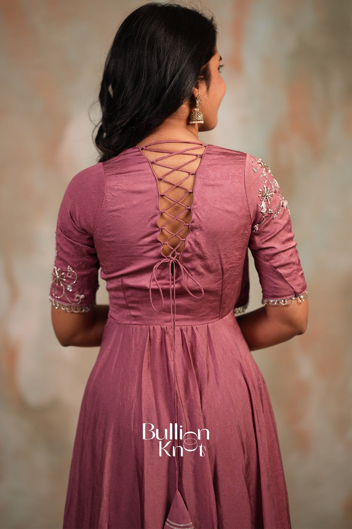 Pink silk long gown with embroidered sleeves and lace-up back detail