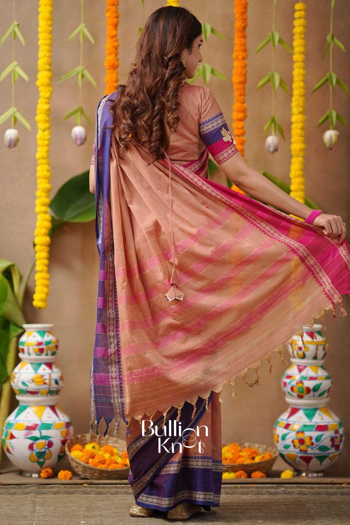 Woman in a traditional saree with decorative background