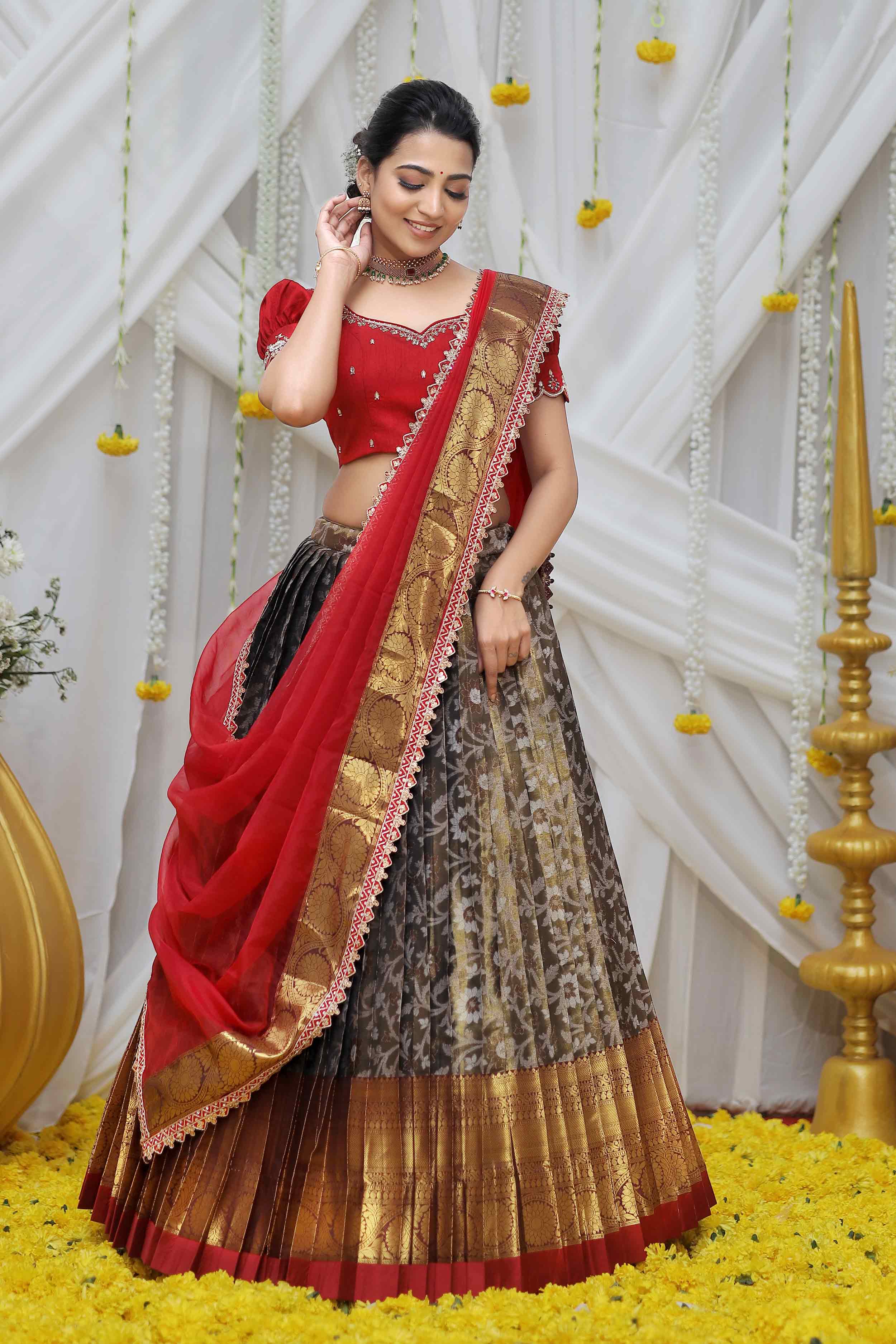 a woman in maroon half saree
