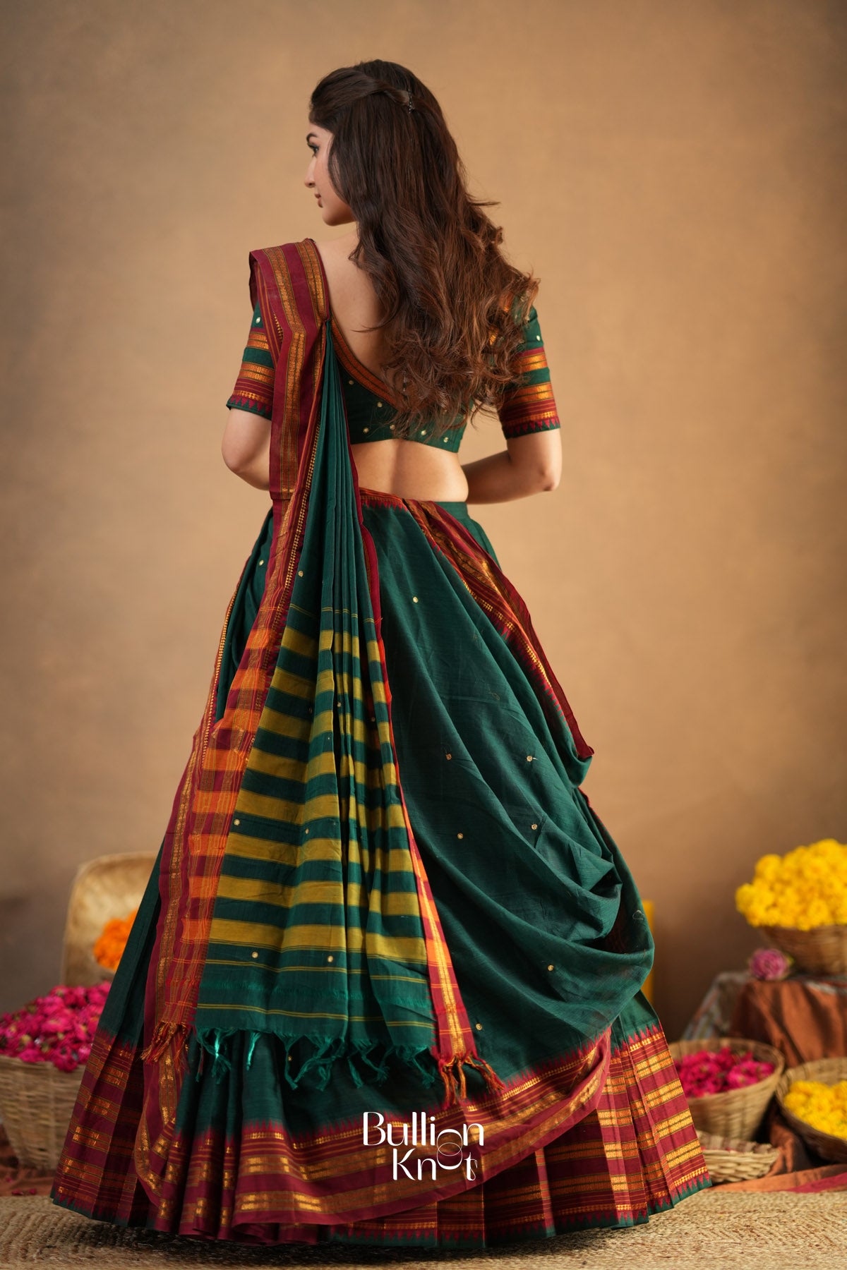 Woman wearing a traditional saree with a colorful pattern