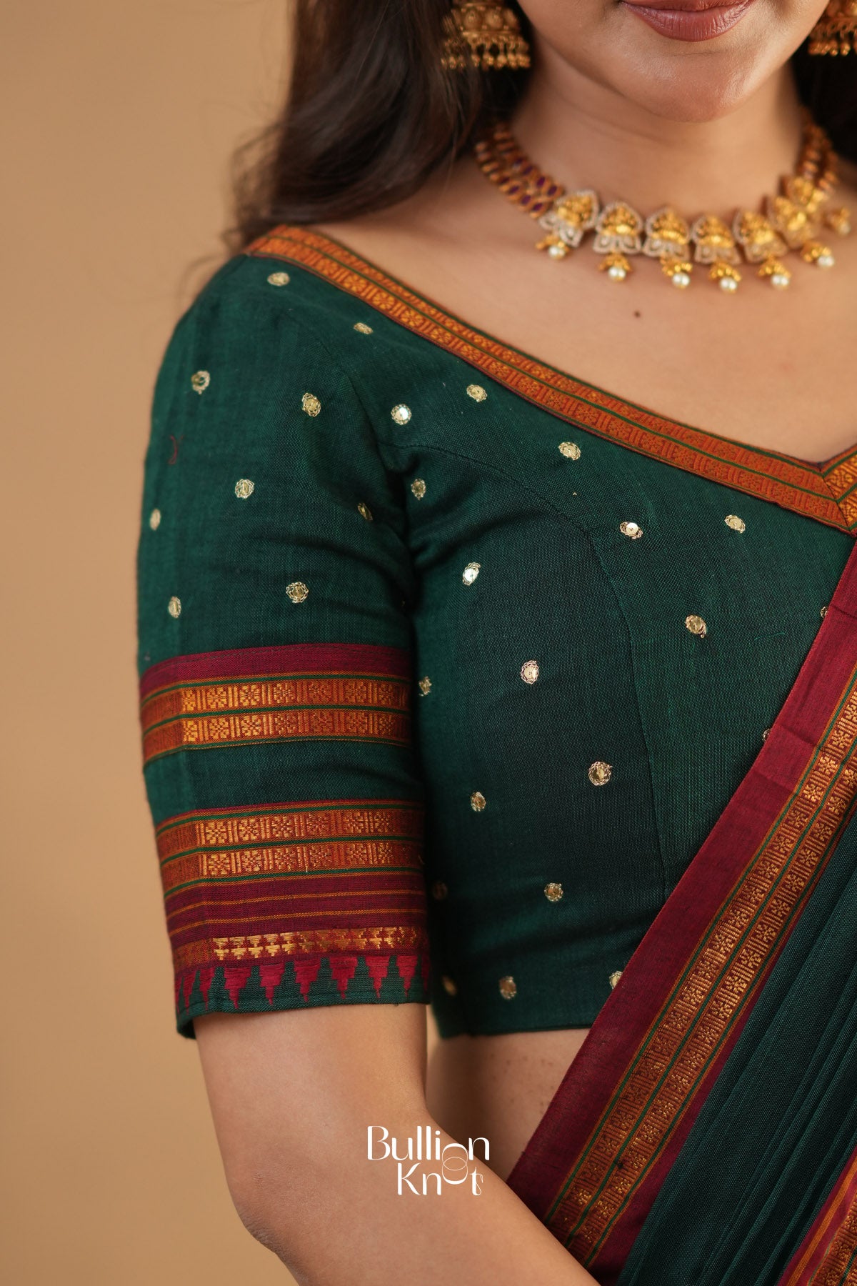 Green saree with gold and red details