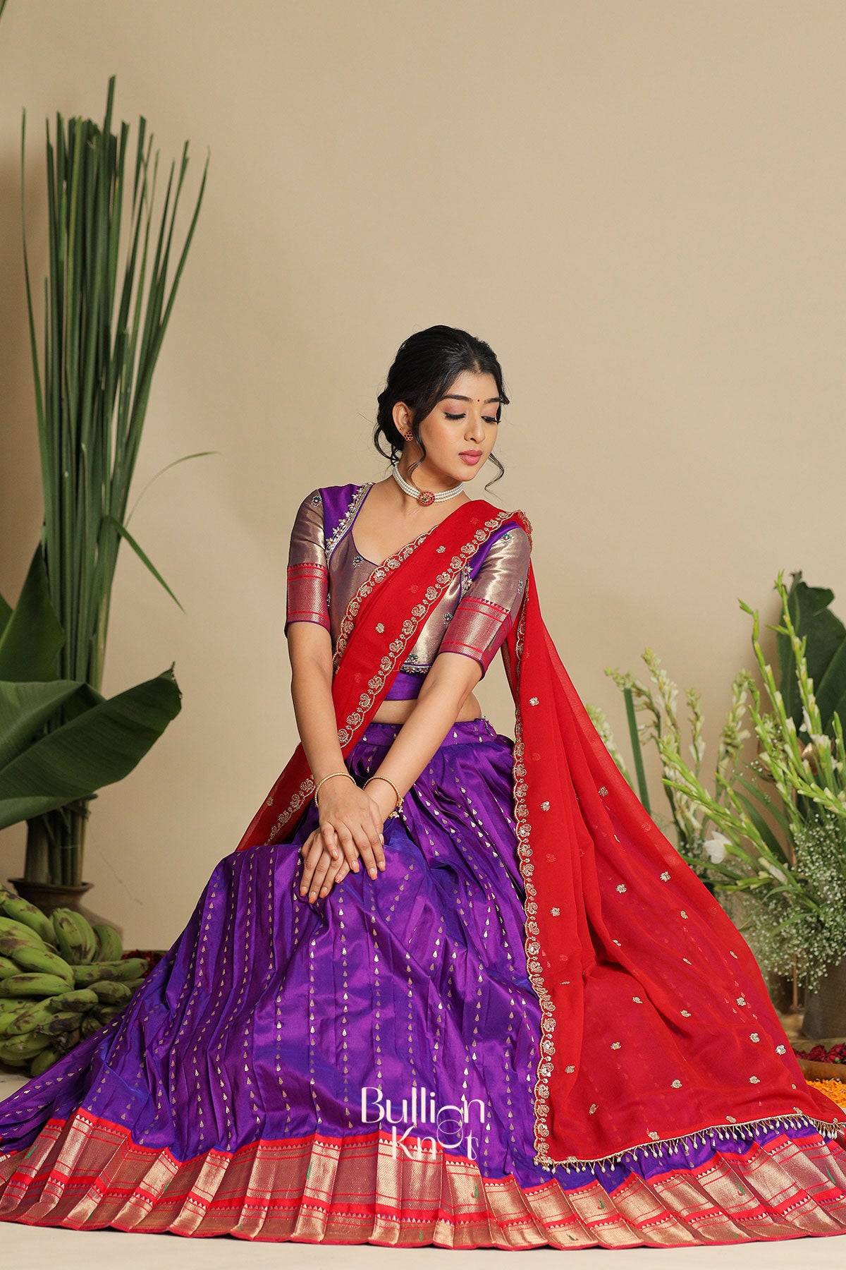 a women in gita pethani lehenga set in purple and red