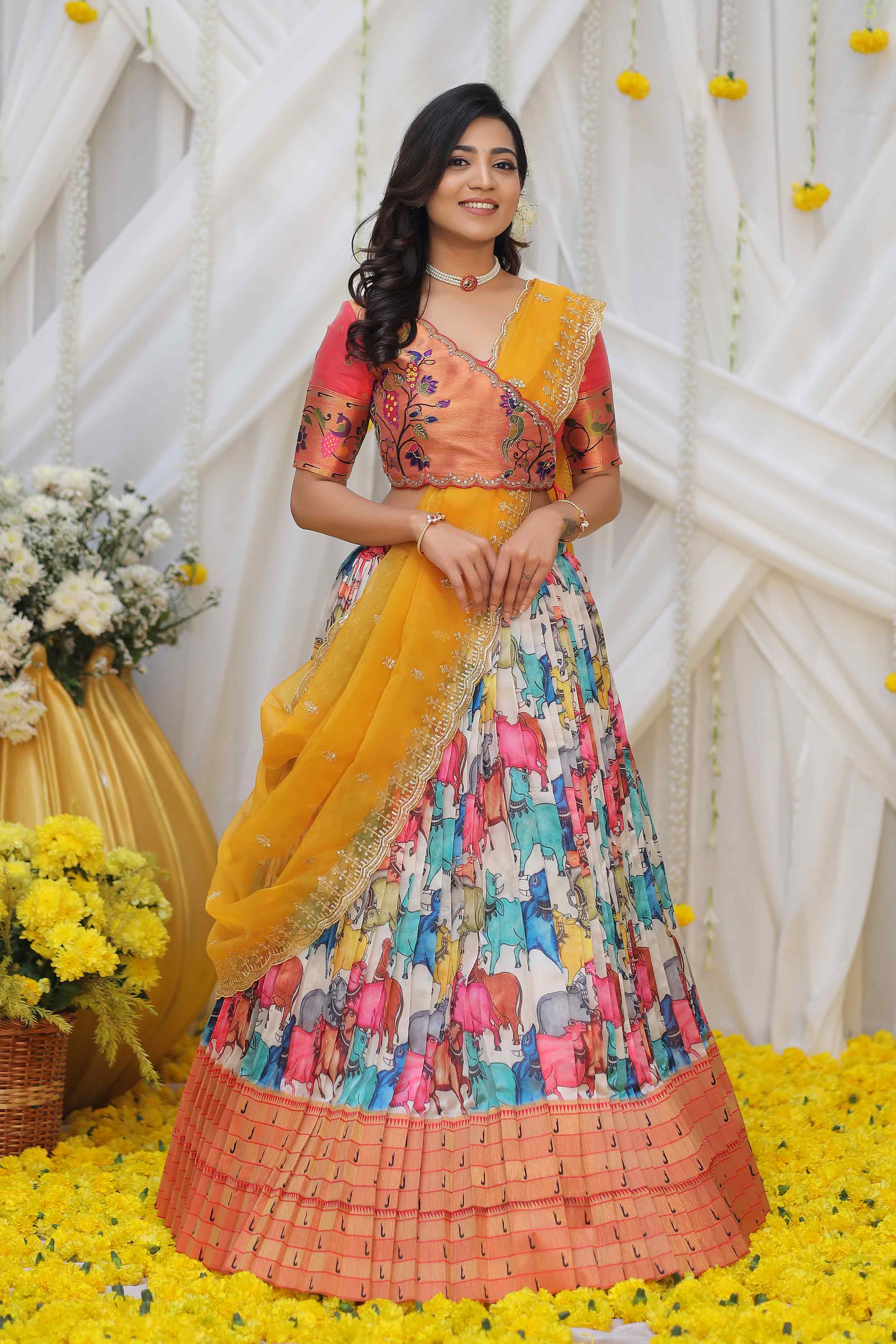 a woman in yellow and white pethani silk half saree