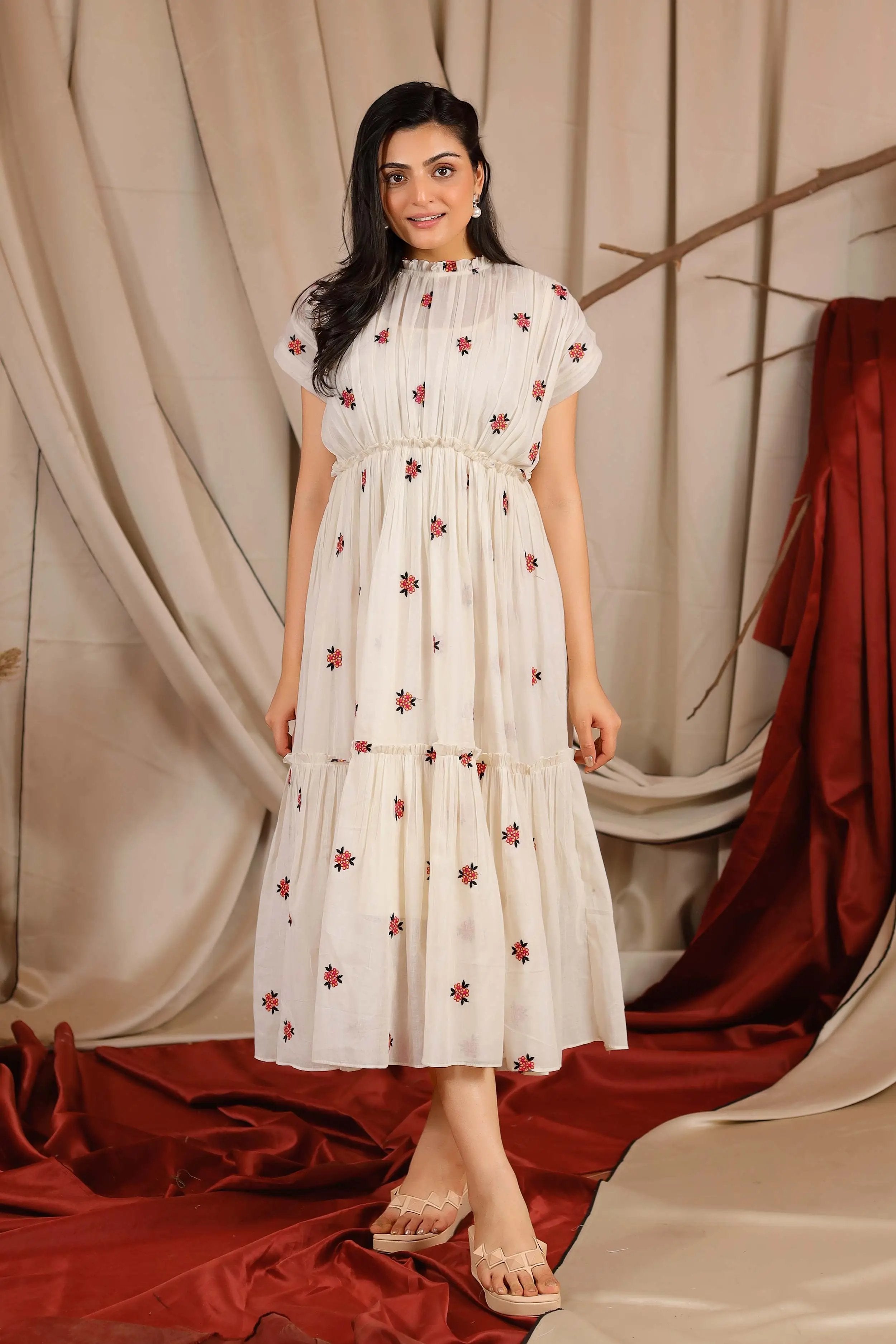 a woman in off white midi dress