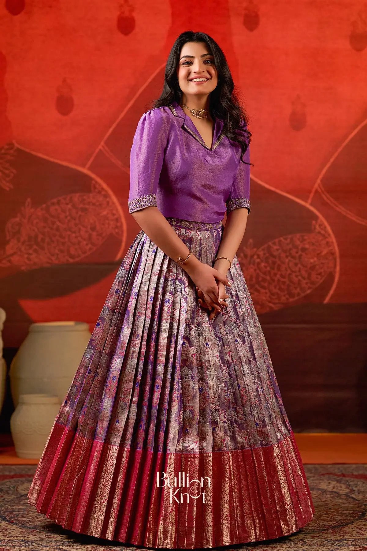 Exclusive Lehenga - Azaira Indo Western in Red at bullionknot featuring a pleated brocade skirt with red border and purple blouse, ideal for festive wear.