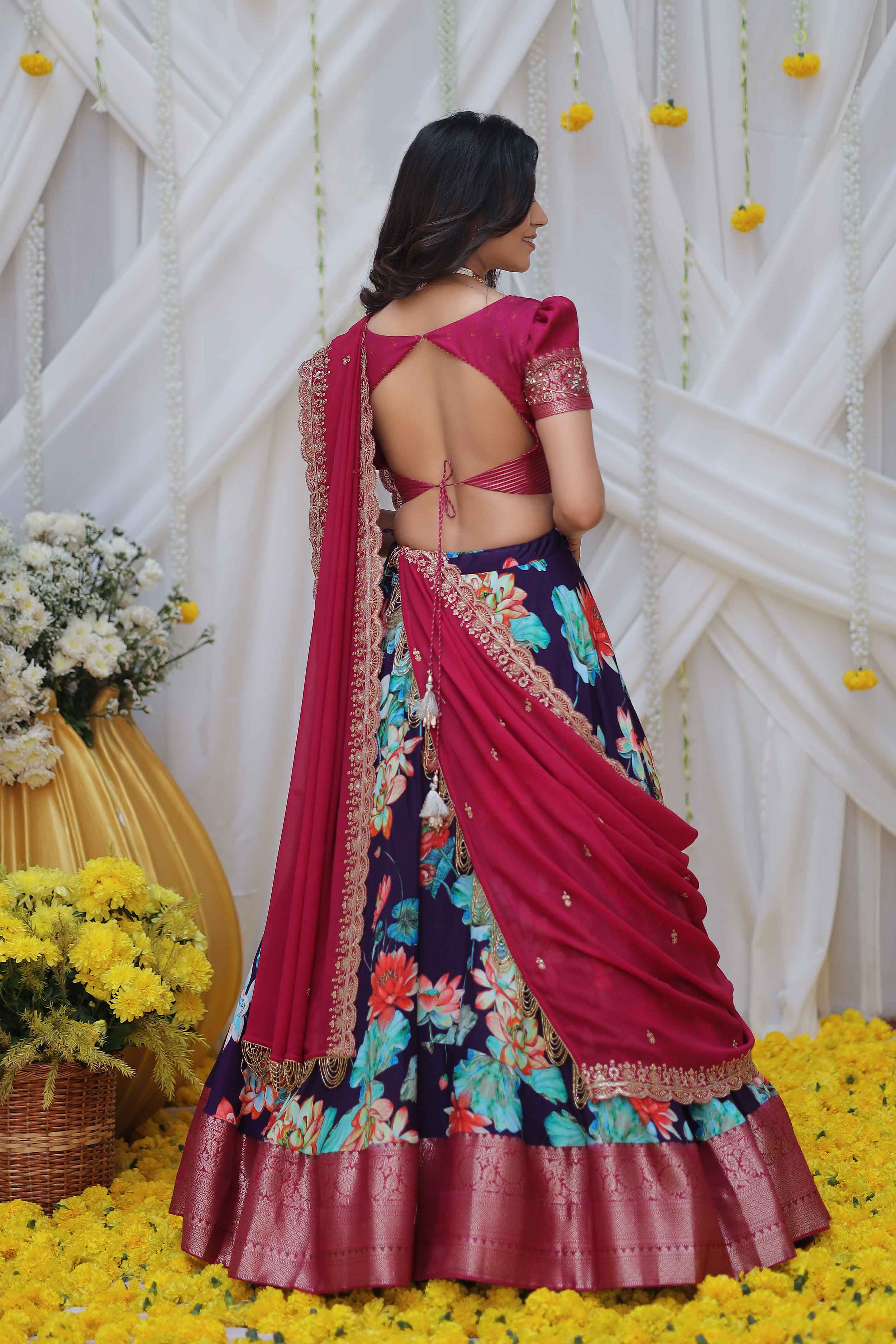 a woman in magenta and purple pattu half saree