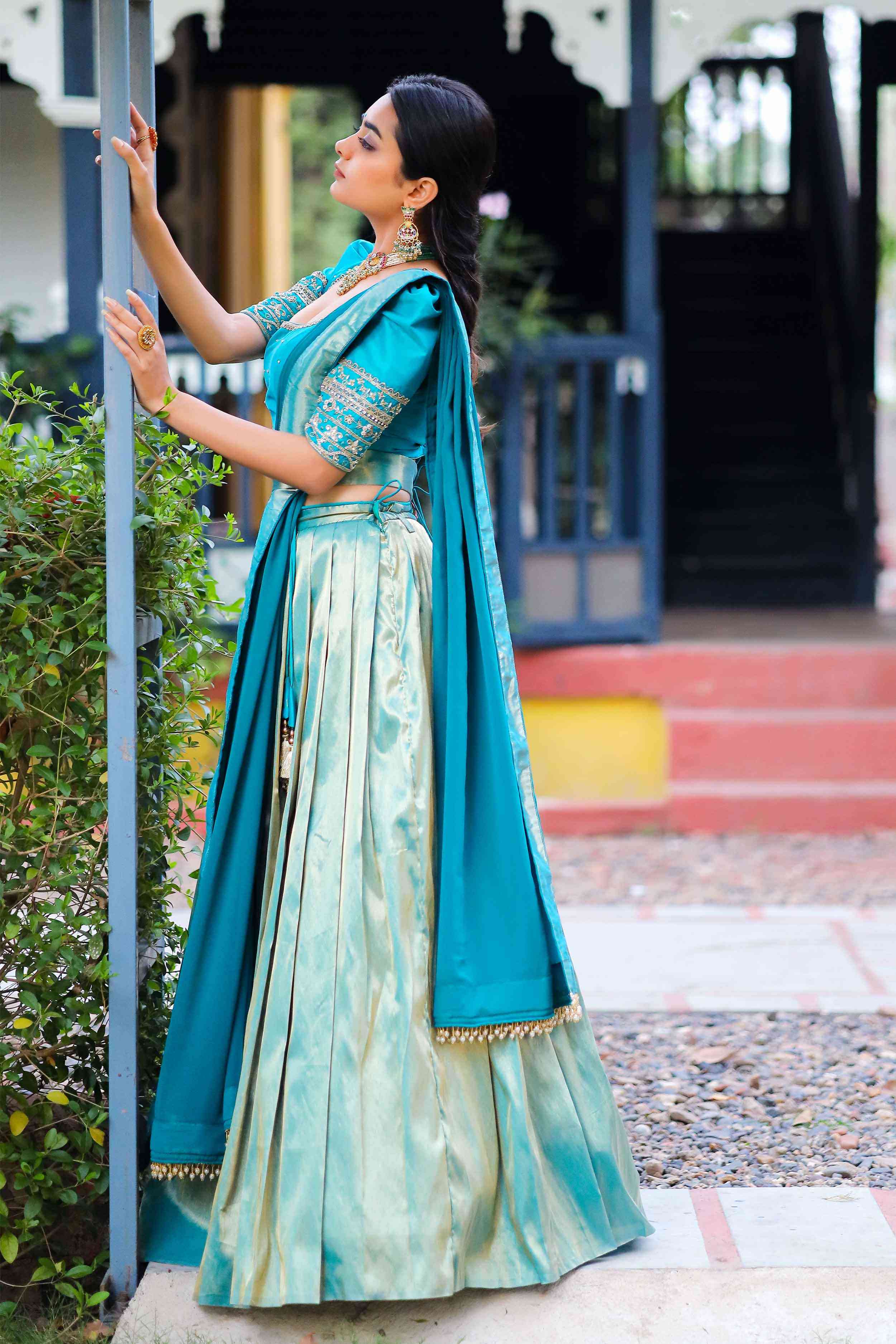 a woman in blue lehenga set