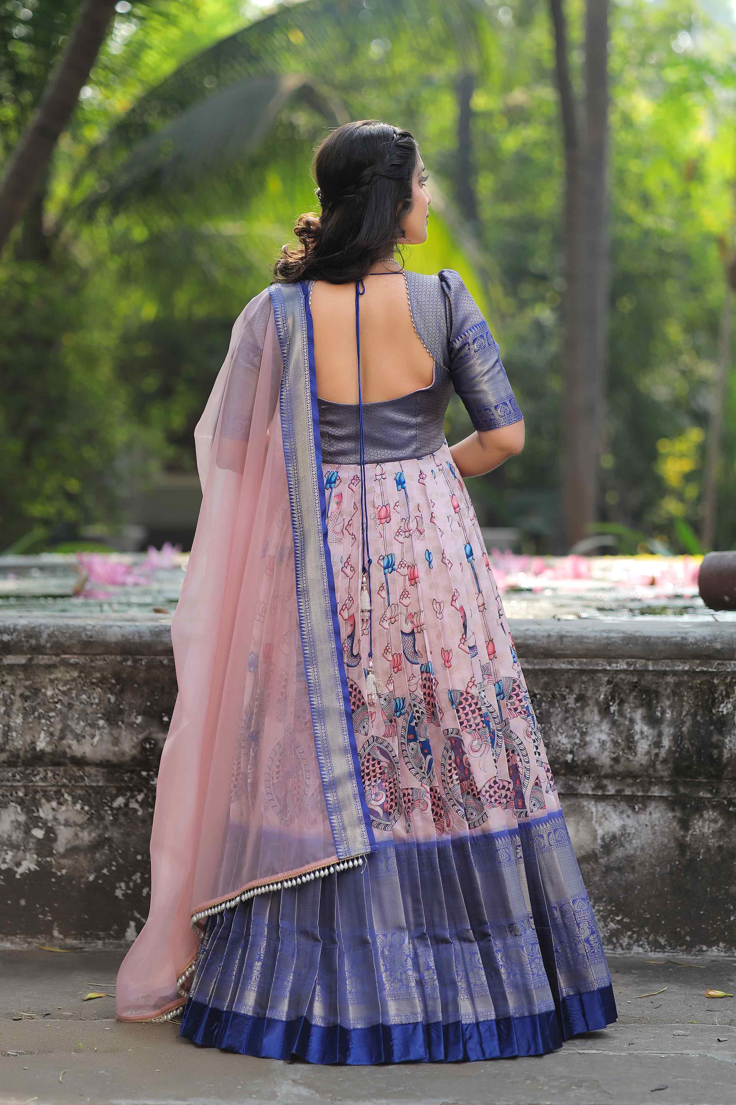 a woman in a blue and pink banarasi pattu suit