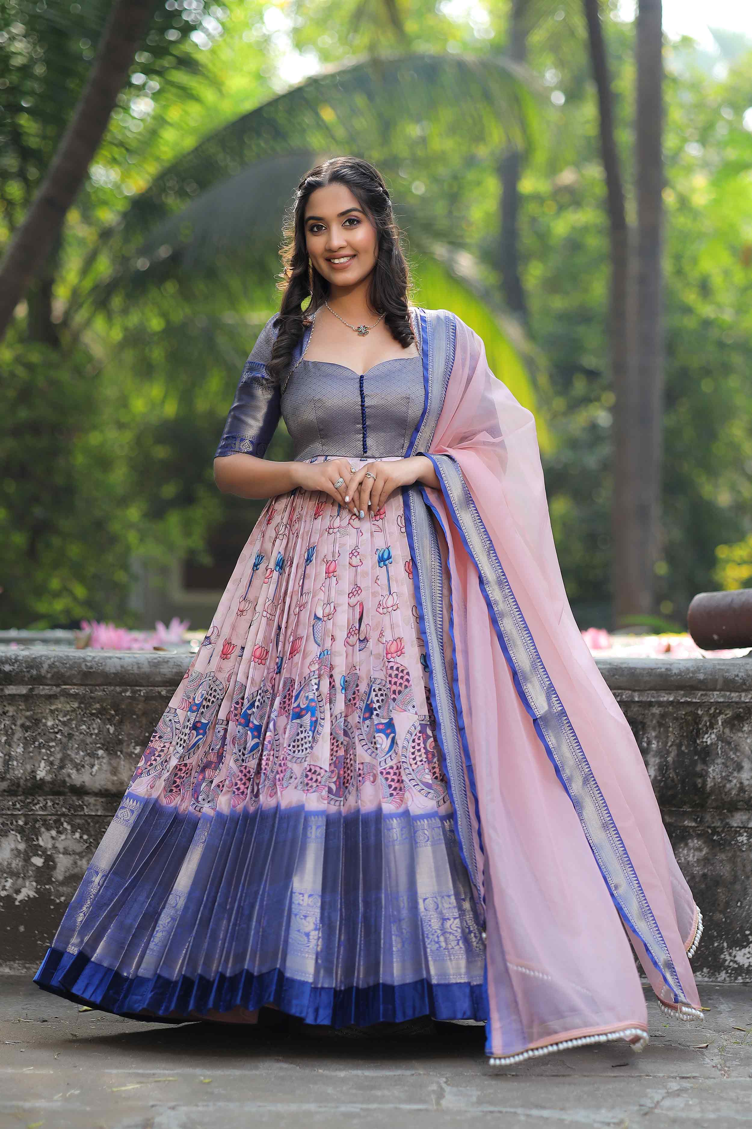 a woman in a pink and blue lehenga