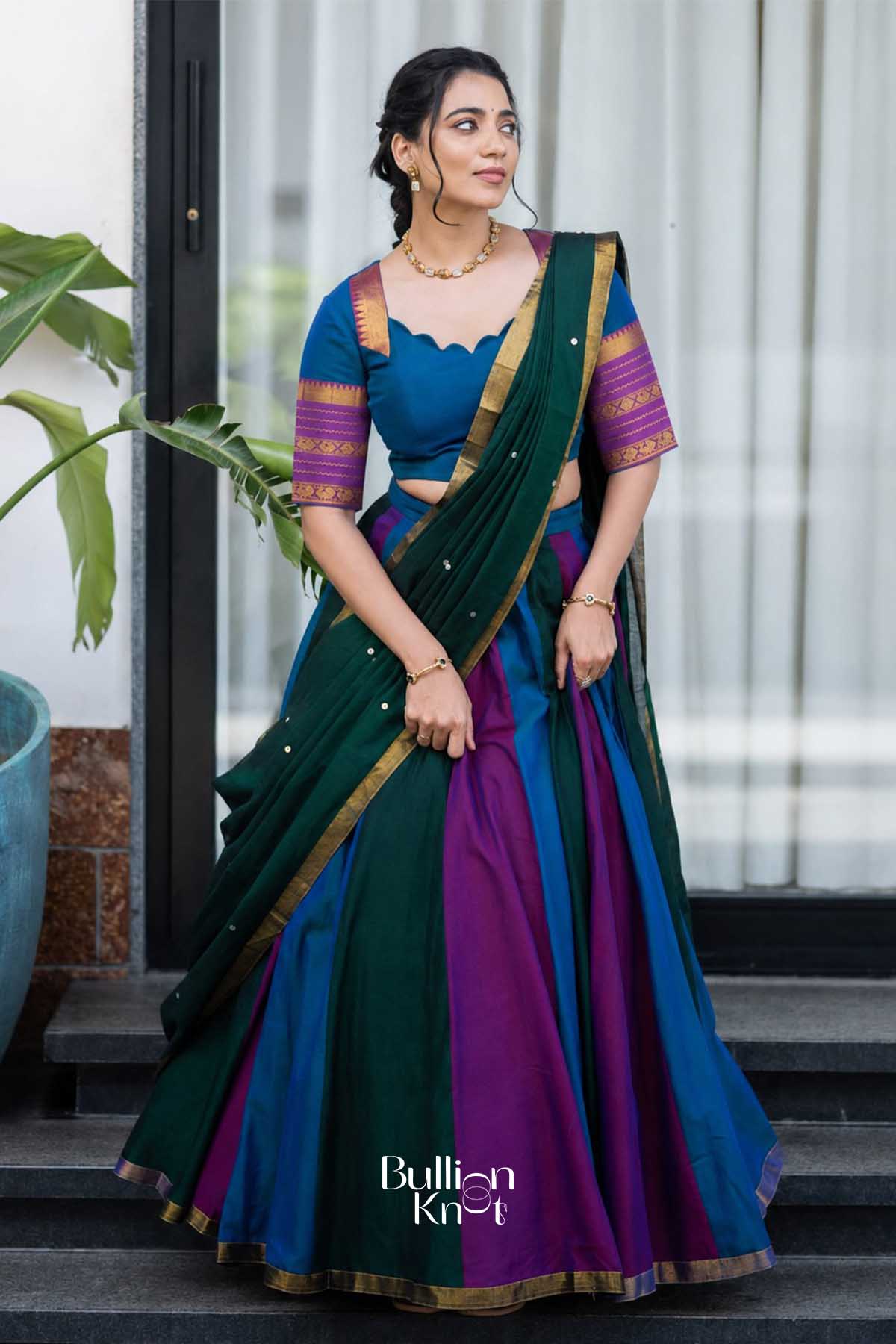 Elegant multicolor handloom half saree in blue, purple, green with gold border, worn with matching blouse, perfect for festive celebrations