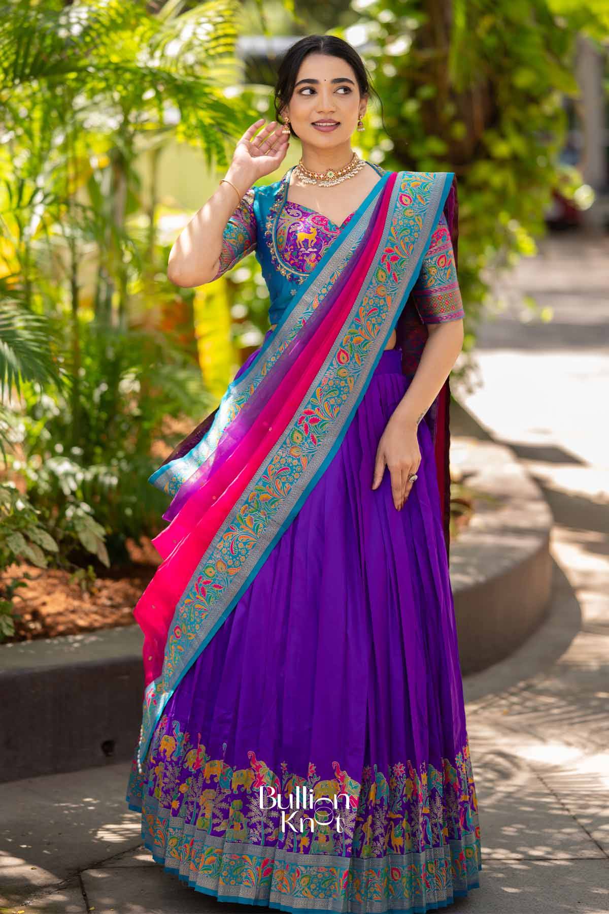 Elegant purple silk lehenga with intricate multicolor embroidery, paired with a matching embroidered dupatta, perfect for traditional occasions.