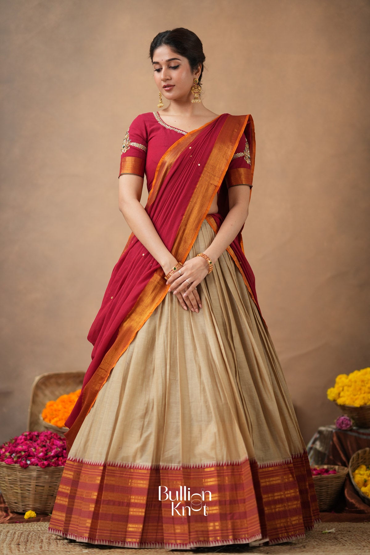 Woman wearing a traditional saree with a brown background