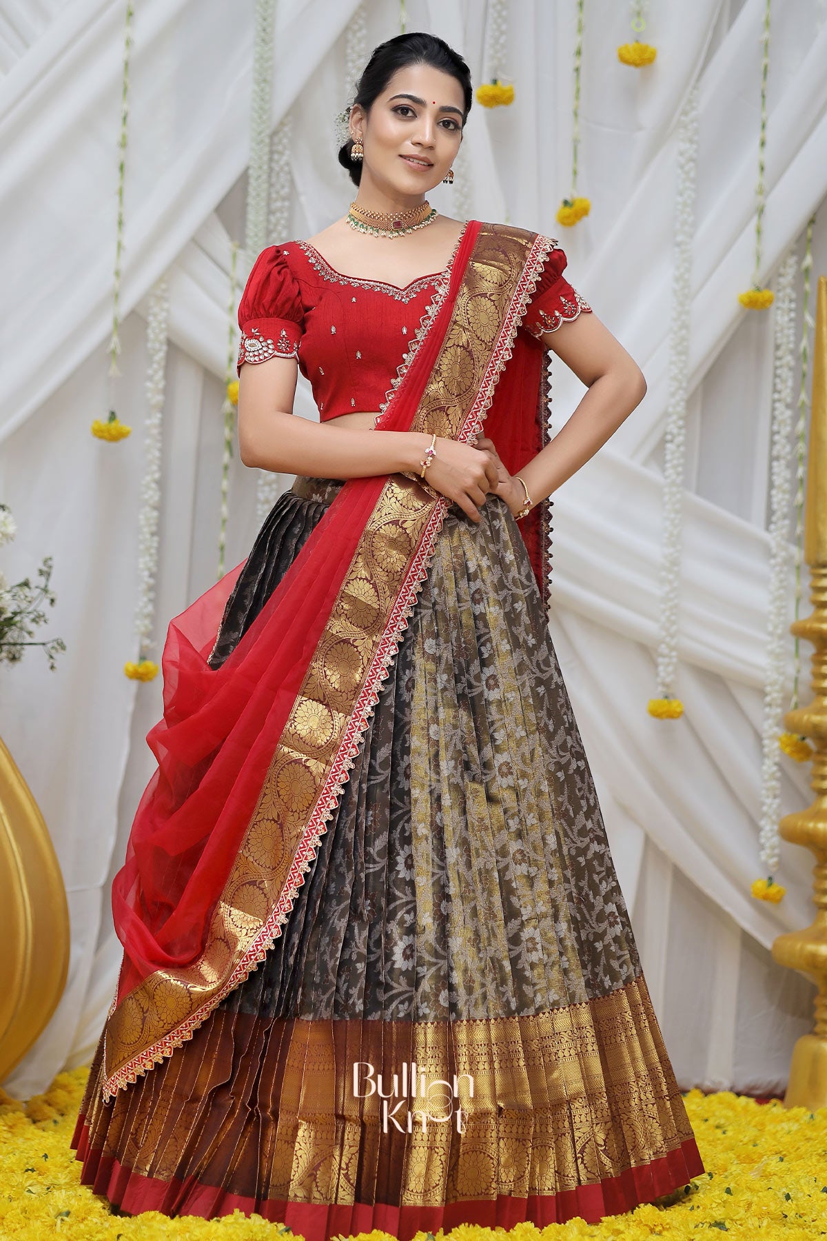 a women showing front side design of wearing ganga banarasi lehenga