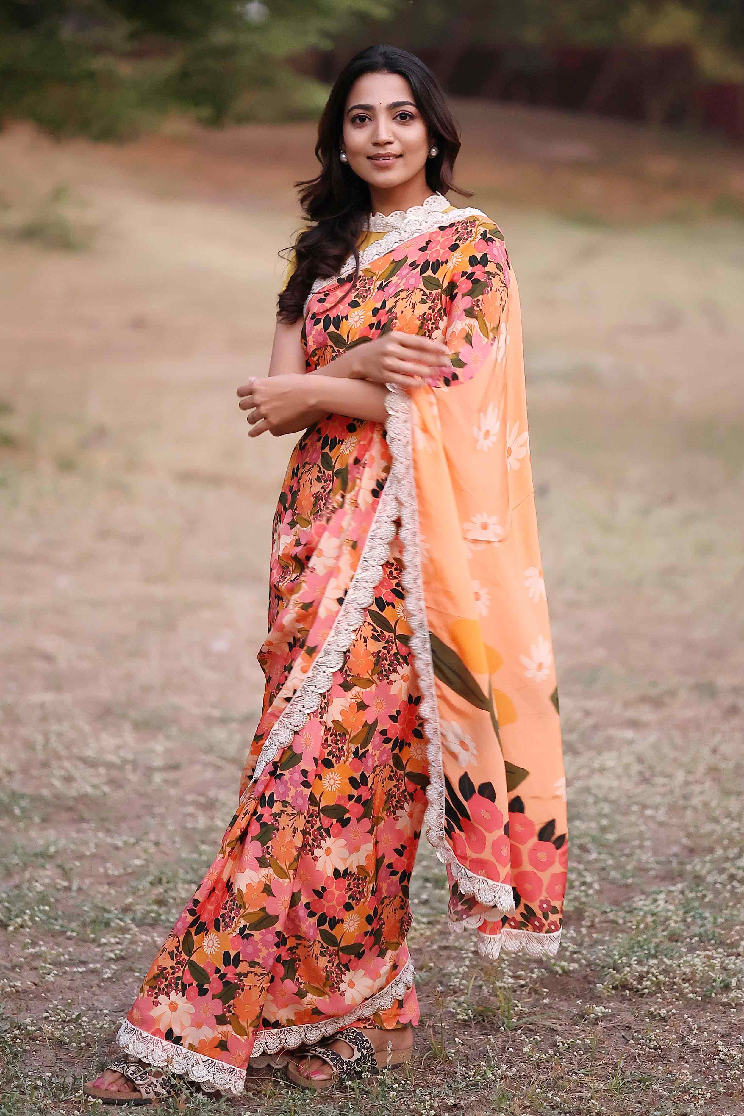 a woman in retro print peach floral saree